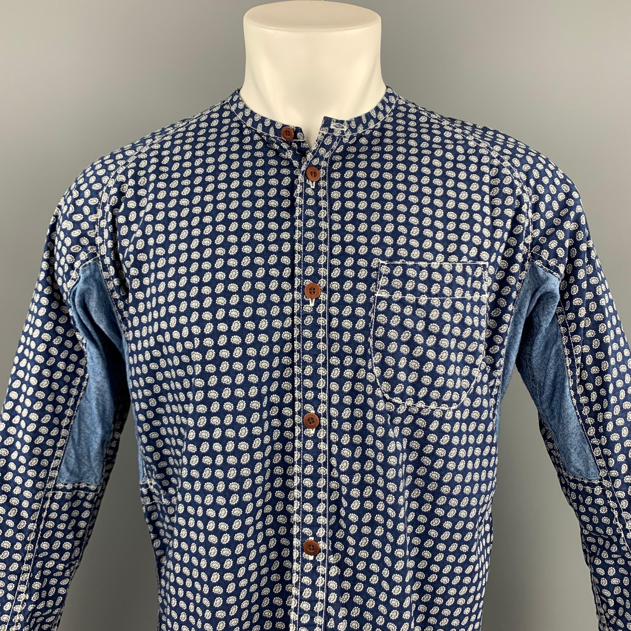 JUNYA WATANABE long sleeve shirt comes in a indigo print cotton featuring a button up style, front pocket, and a nehru collar. Made in Japan.

Very Good Pre-Owned Condition.
Marked: M / AD 2014

Measurements:

Shoulder: 17 in. 
Chest: 44 in.
Sleeve: