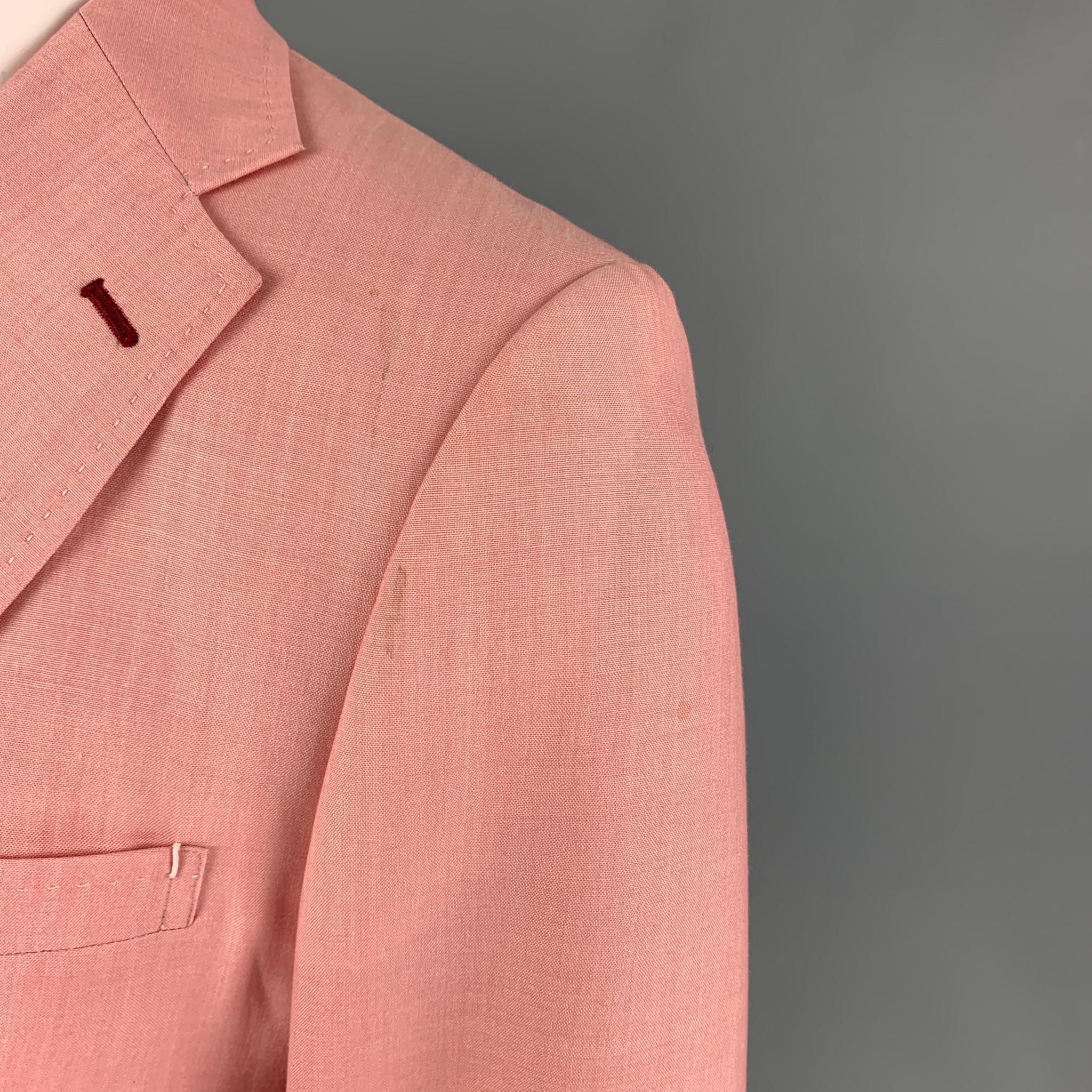 JUNYA WATANABE sport coat comes in a pink wool blend wth a half liner featuring a notch lapel, patch pockets, contrast stitching, single back vent, and a three button closure. Made in Japan. 

Very Good Pre-Owned Condition. Light discoloration at