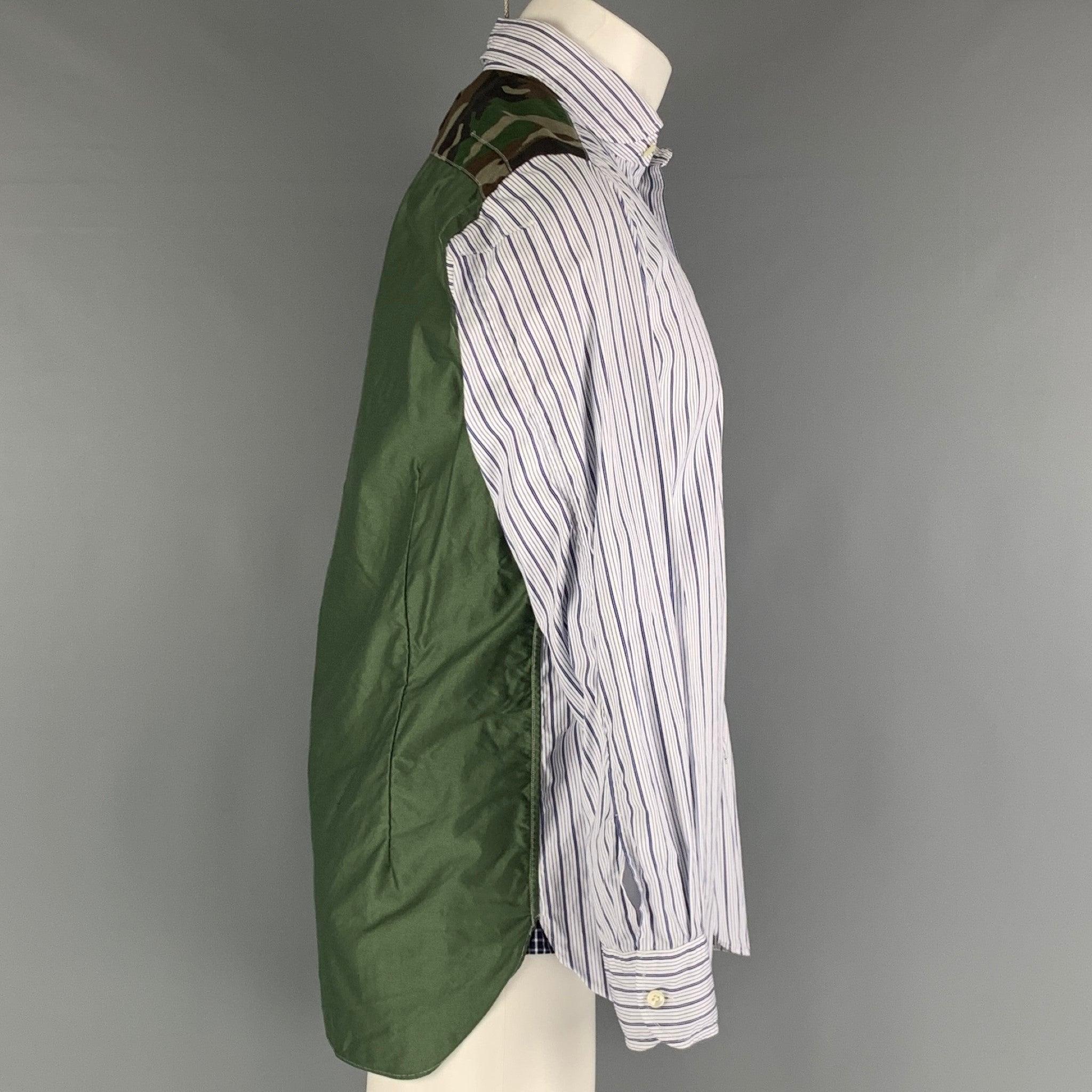 JUNYA WATANABE AD2018 long sleeve shirt comes in a navy and white striped cotton woven featuring camo yoke detail, cotton green woven material back panel, and a button up closure. Made in Japan.Excellent Pre-Owned Condition.  

Marked:   M