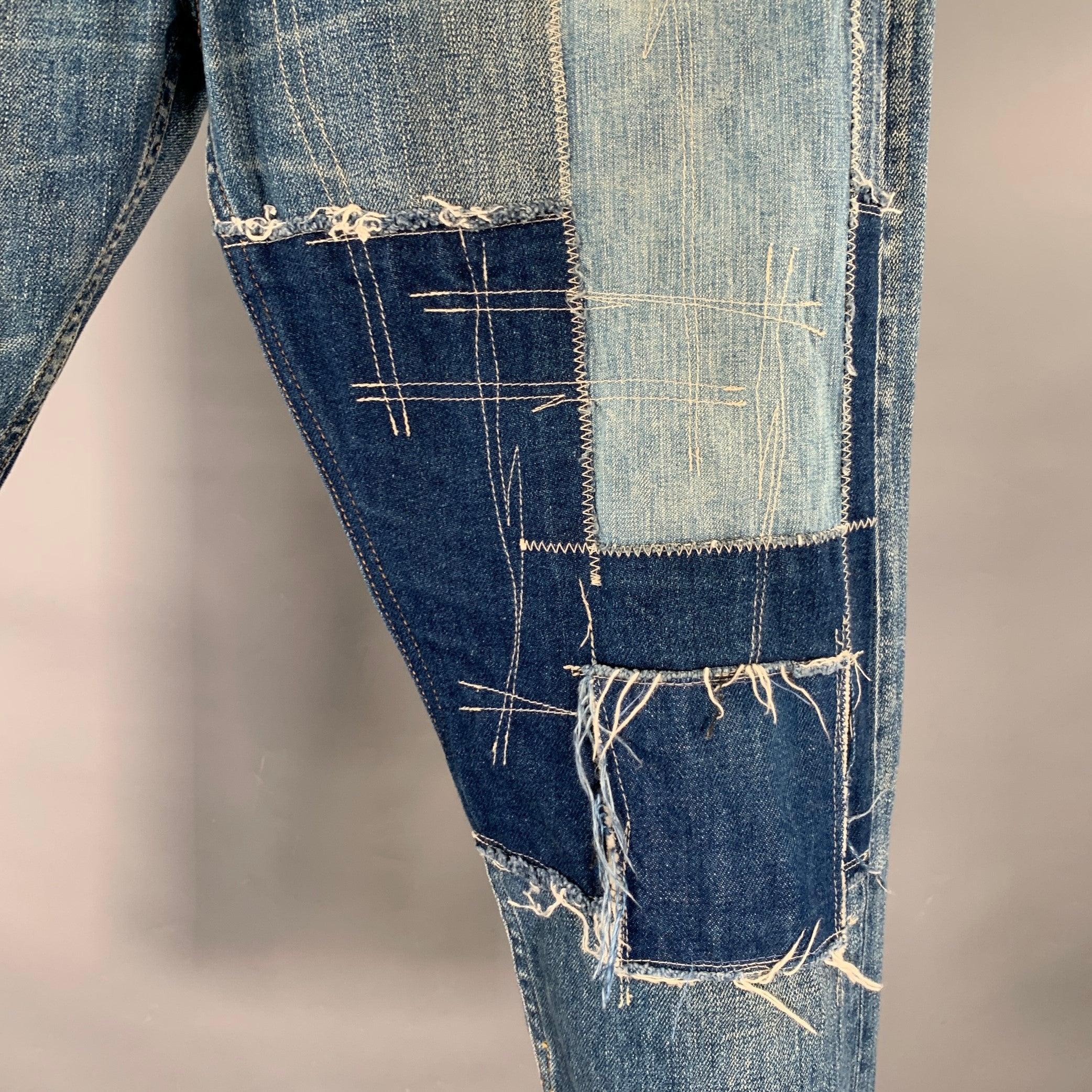 JUNYA WATANABE DENIM selvedge jeans
in a blue cotton denim featuring a navy patchwork visible mending design, five pockets, and zip fly closure. Made in Japan.Excellent Pre-Owned Condition. 

Marked:   S 

Measurements: 
  Waist: 33 inches Rise: 10