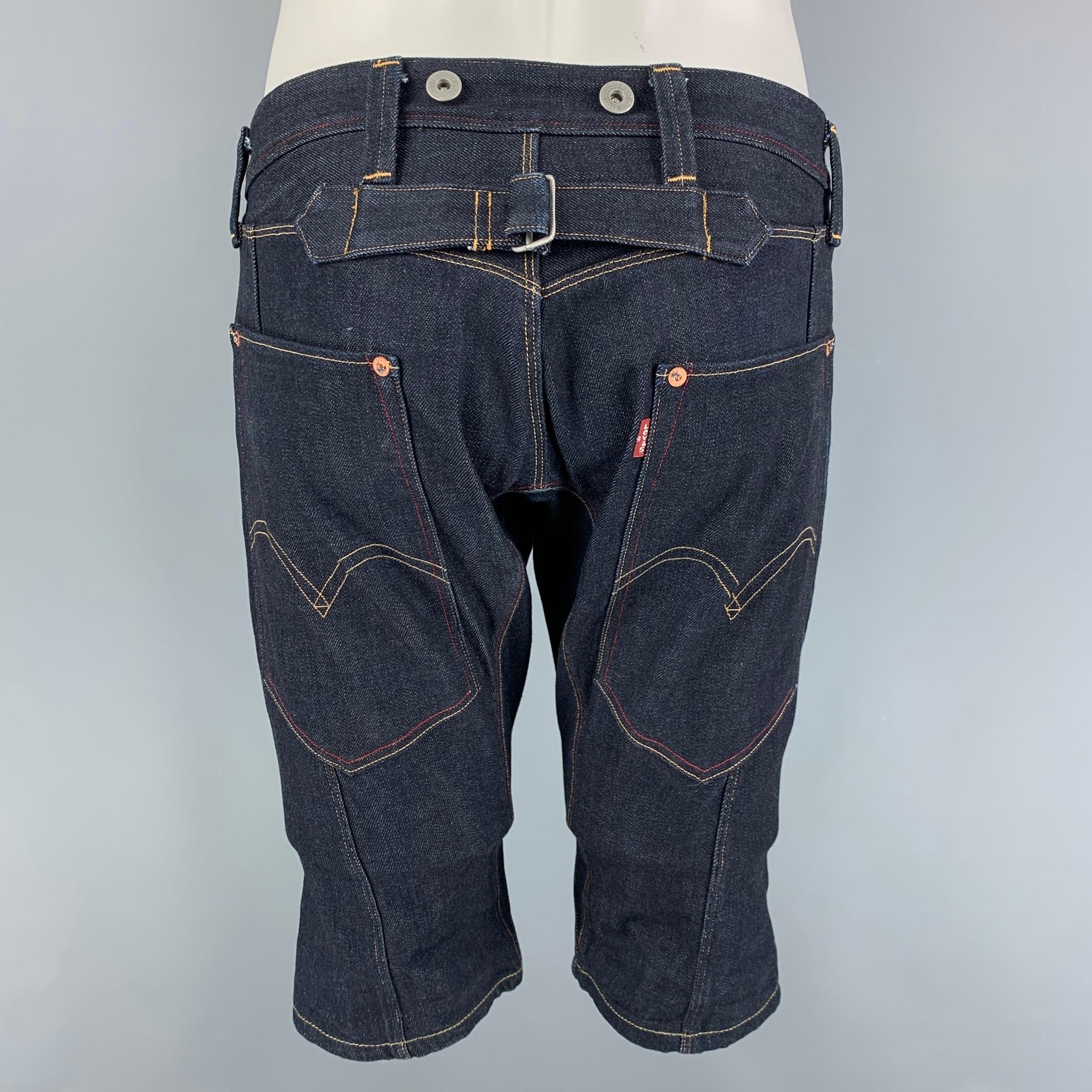 JUNYA WATANABE shorts comes in a indigo denim featuring a back strap, contrast stitching, and a zip fly closure. Made in Japan. 

Very Good Pre-Owned Condition.
Marked: S

Measurements:

Waist: 32 in.
Rise: 11 in.
Inseam: 13 in. 