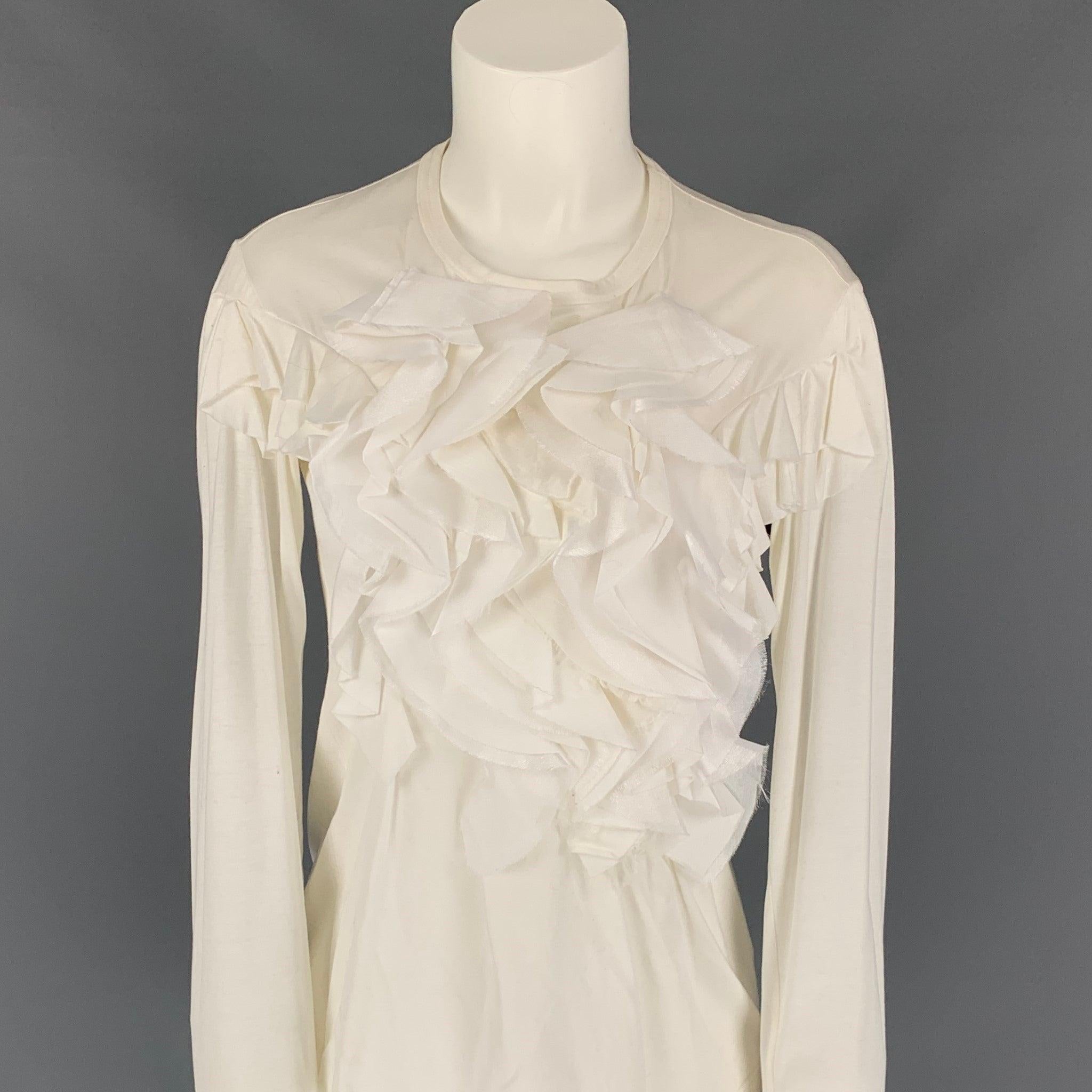 JUNYA WATANABE blouse comes in a white material with a front ruffled design featuring long sleeves and a crew-neck. Made in Japan.
Very Good
Pre-Owned Condition. 

Marked:   S 

Measurements: 
 
Shoulder: 16.5 inches  Bust: 32 inches  Sleeve: 25