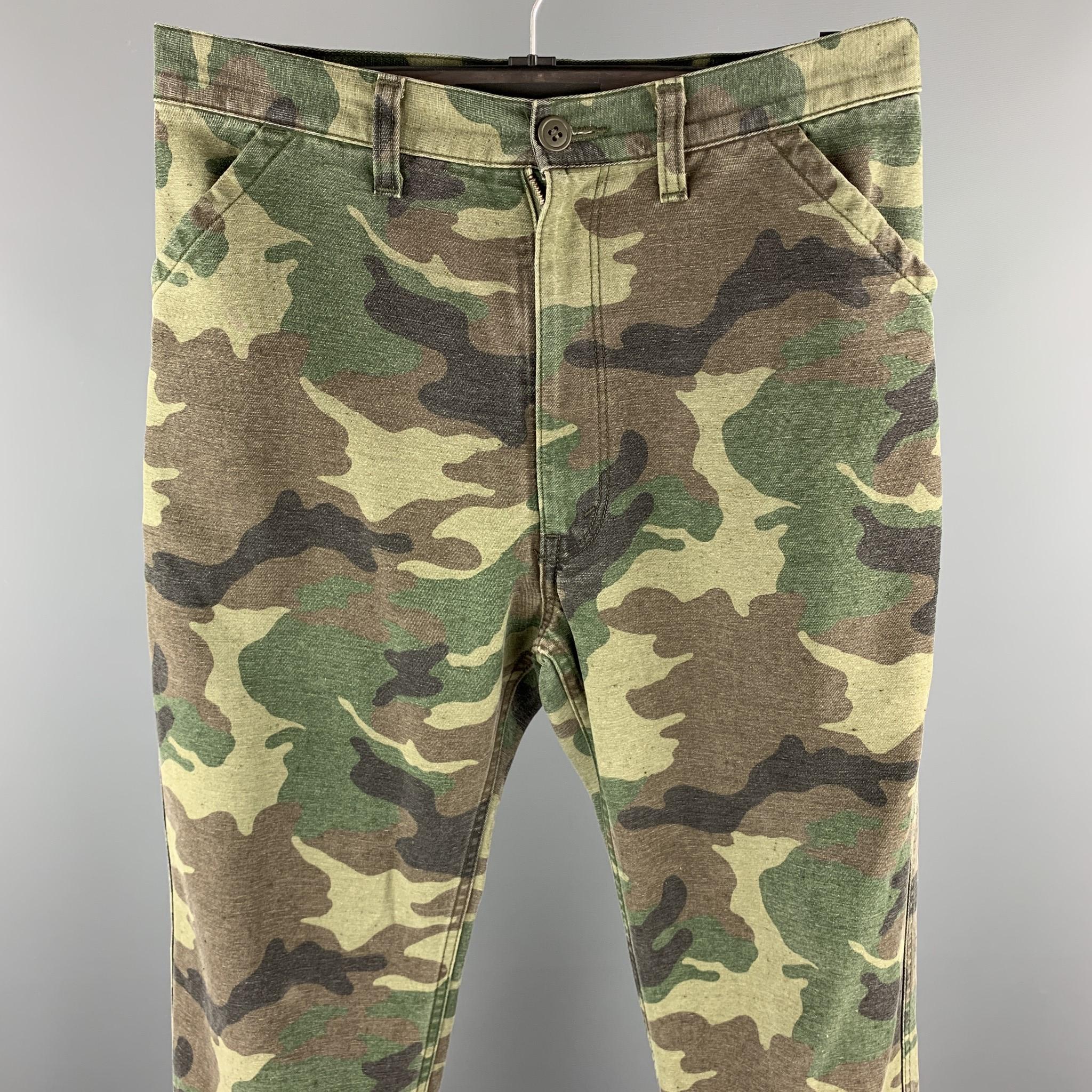 JUNYA WATANABE pants comes in a olive camouflage rayon blend featuring a cropped style, back patch pockets, back belt, and a zip fly closure. Made in Japan.

Excellent Pre-Owned Condition.
Marked: JP XS / AD2010

Measurements:

Waist: 32 in. 
Rise: