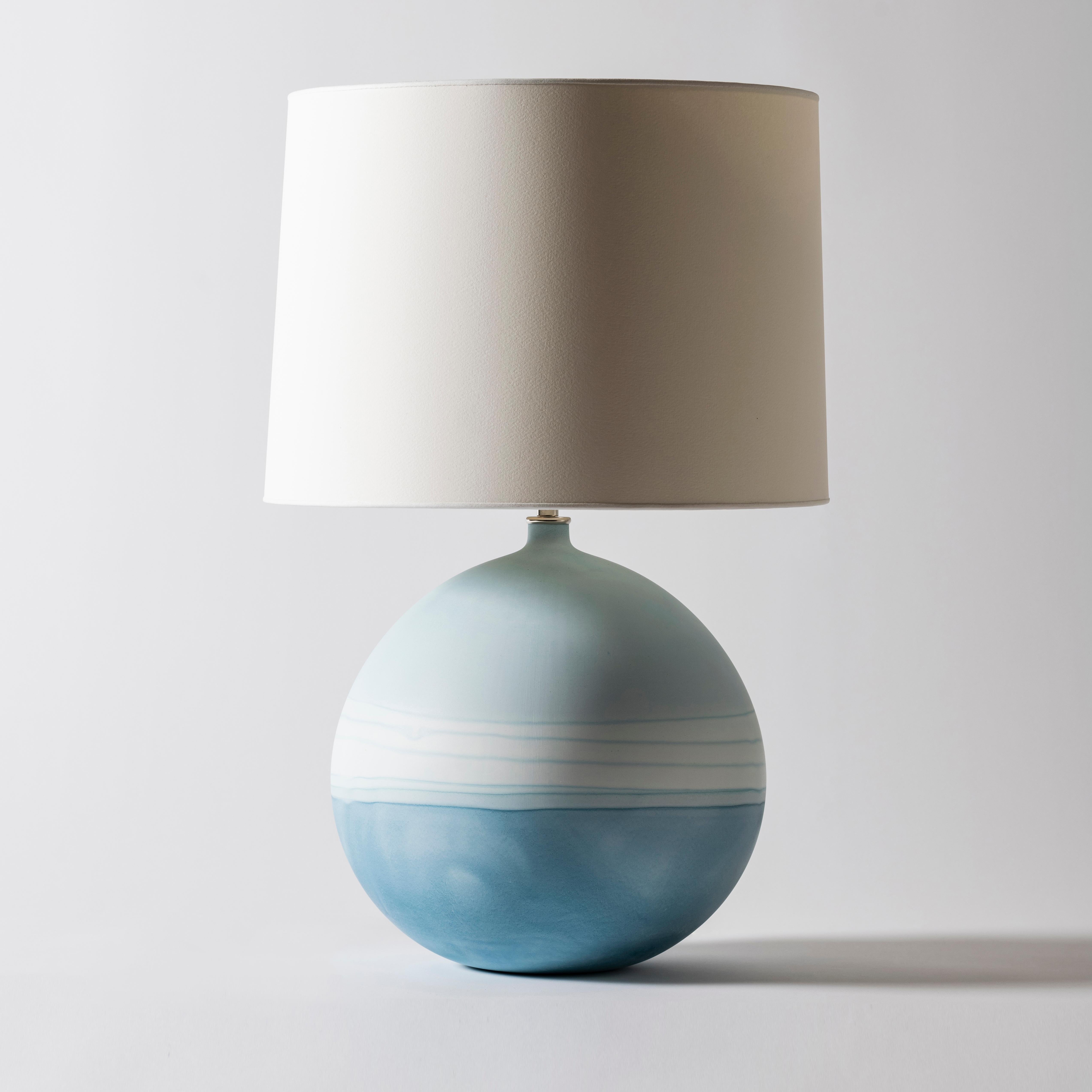 Jupiter lamp in blue Ombré by Elyse Graham
Dimensions: D38 x H61 cm
Materials: plaster, resin, cotton rag paper, brass, nickel. Hardware: polished nickel-plated brass uno threaded socket
withturn key switch, in-line dimmer.
Molded, dyed, and