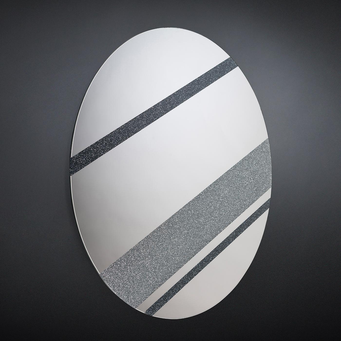 This exquisite mirror renders the planet Jupiter in a striking design by Giorgio Ragazzini. Part of a collection that evokes shapes, distinctive elements, and sizes of the planet in minimalist and evocative silhouettes, this mirror will be an