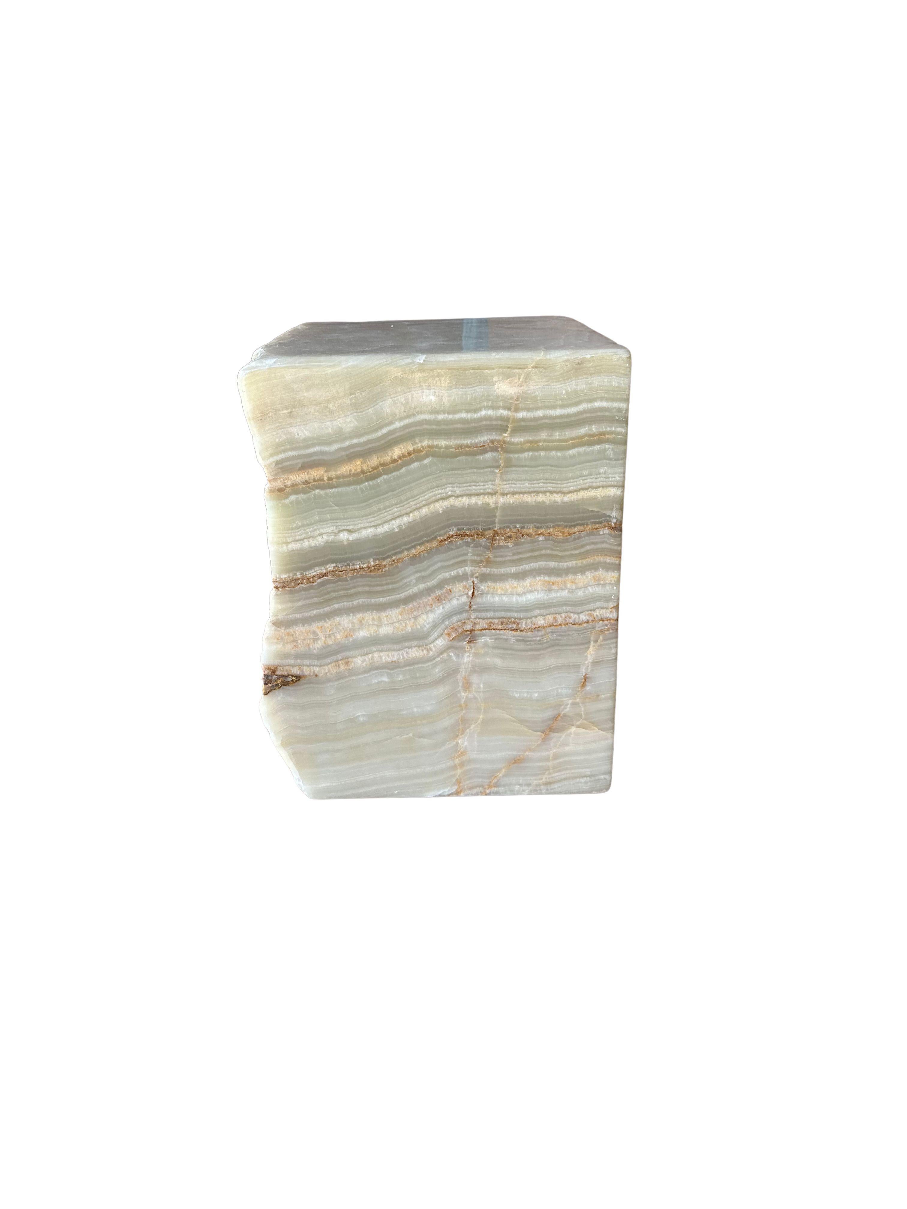A Jupiter onyx solid marble block which serves as a wonderful side table or pedestal. Sourced on the island of Sumatra with a jade green undertone, this raw and organic object features a stunning mix of textures and shades. The mix of smooth and