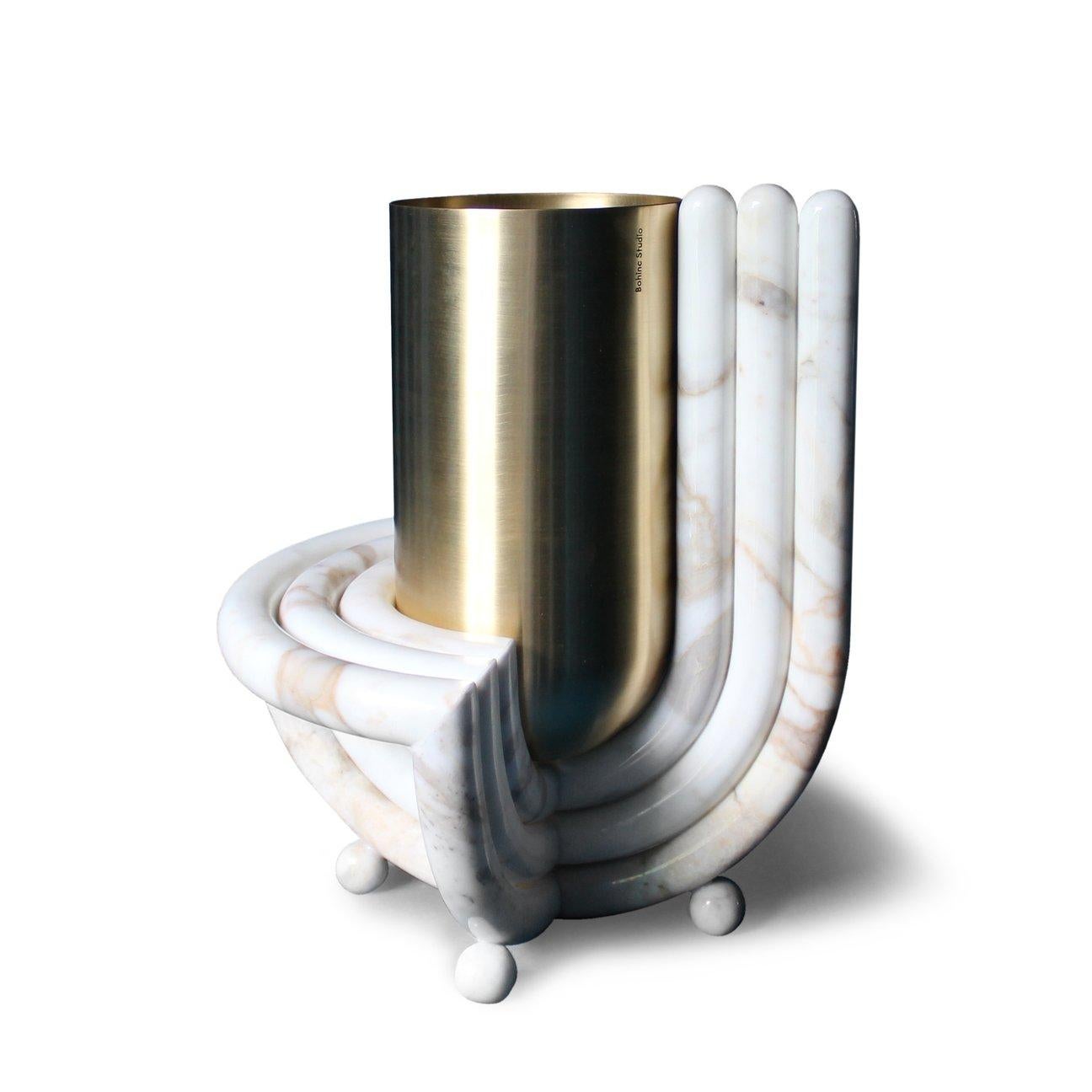 Named after the planet Jupiter, the new Jupiter vase features a brass bullet shaped vase and a base in 3-D milled Carrara marble. The vase can be removed from its rainbow shaped base.

Handmade in Italy using a mix of handmade metalwork and 3-D