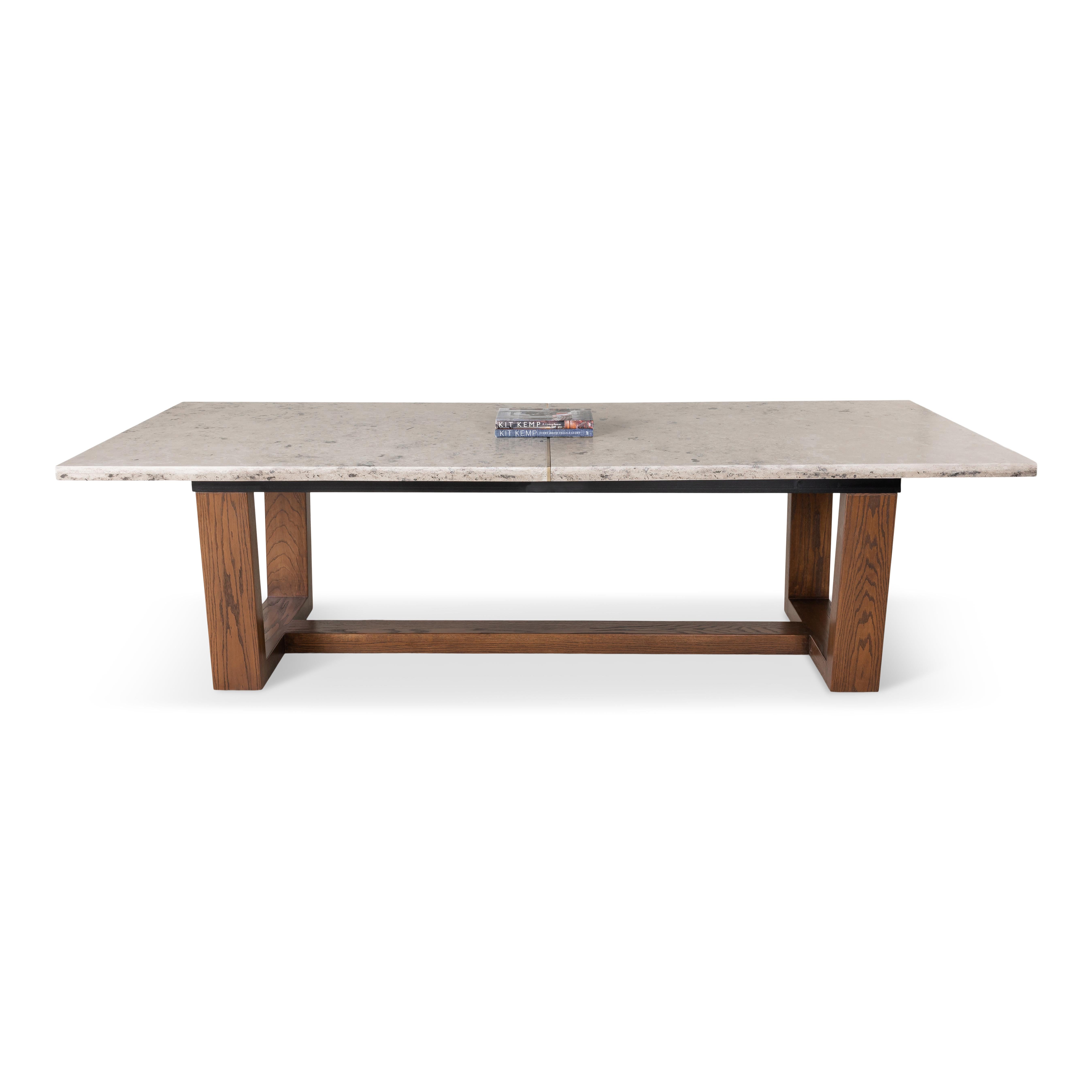 Dining table with jura grey marble top on walnut base with bronze band. 

Dimensions, stone type and metal finish can be customized.
This item is custom and will have a 10 week lead time.