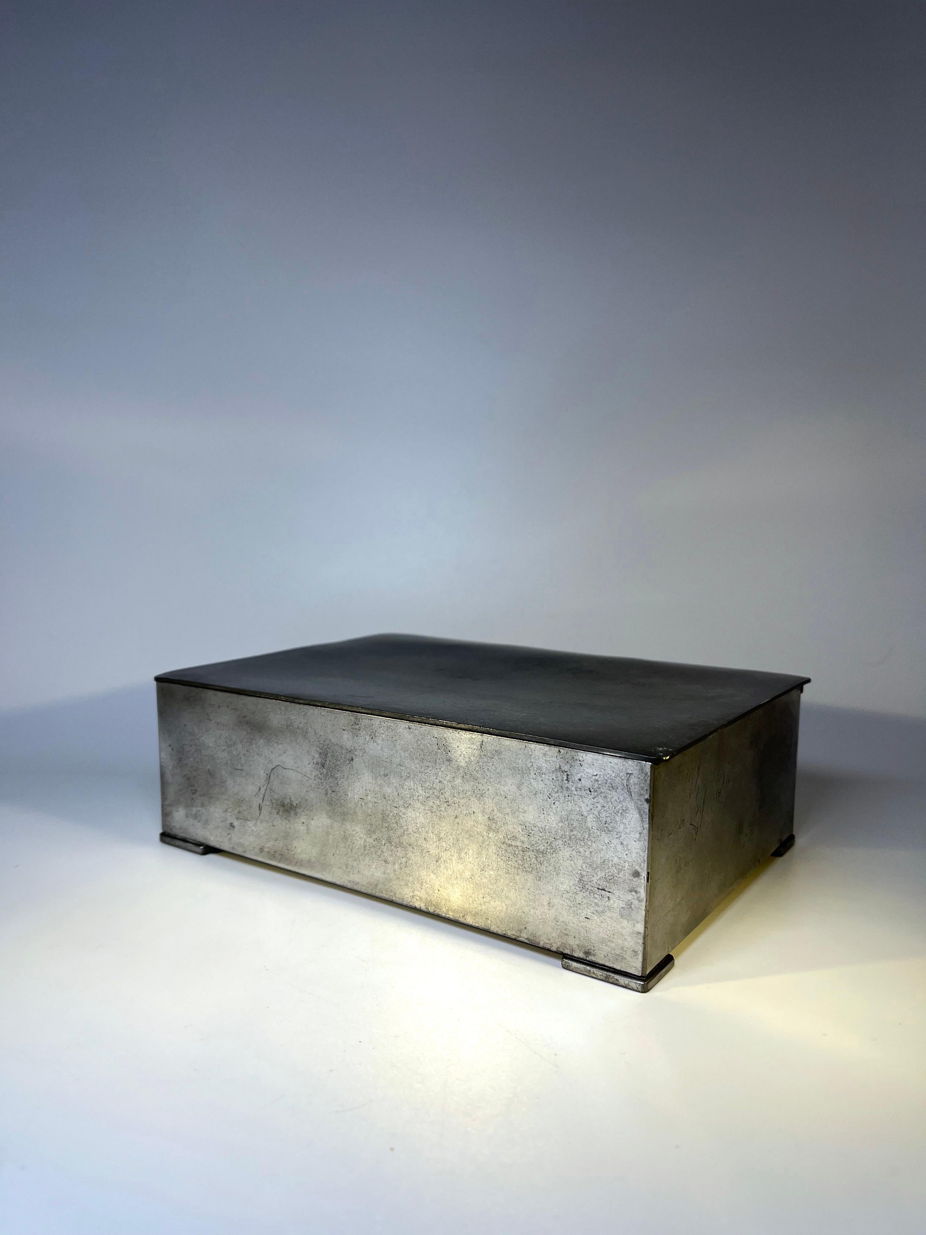 Danish Just Andersen, pewter hinged cigar box, lined with birchwood
Sits on four pewter feet, is fully functional with excellent interior
Circa 1930's
Stamped and numbered 1092 
Height 2.5 inch, Width 7.75 inch, Depth 5.5 inch
In very good