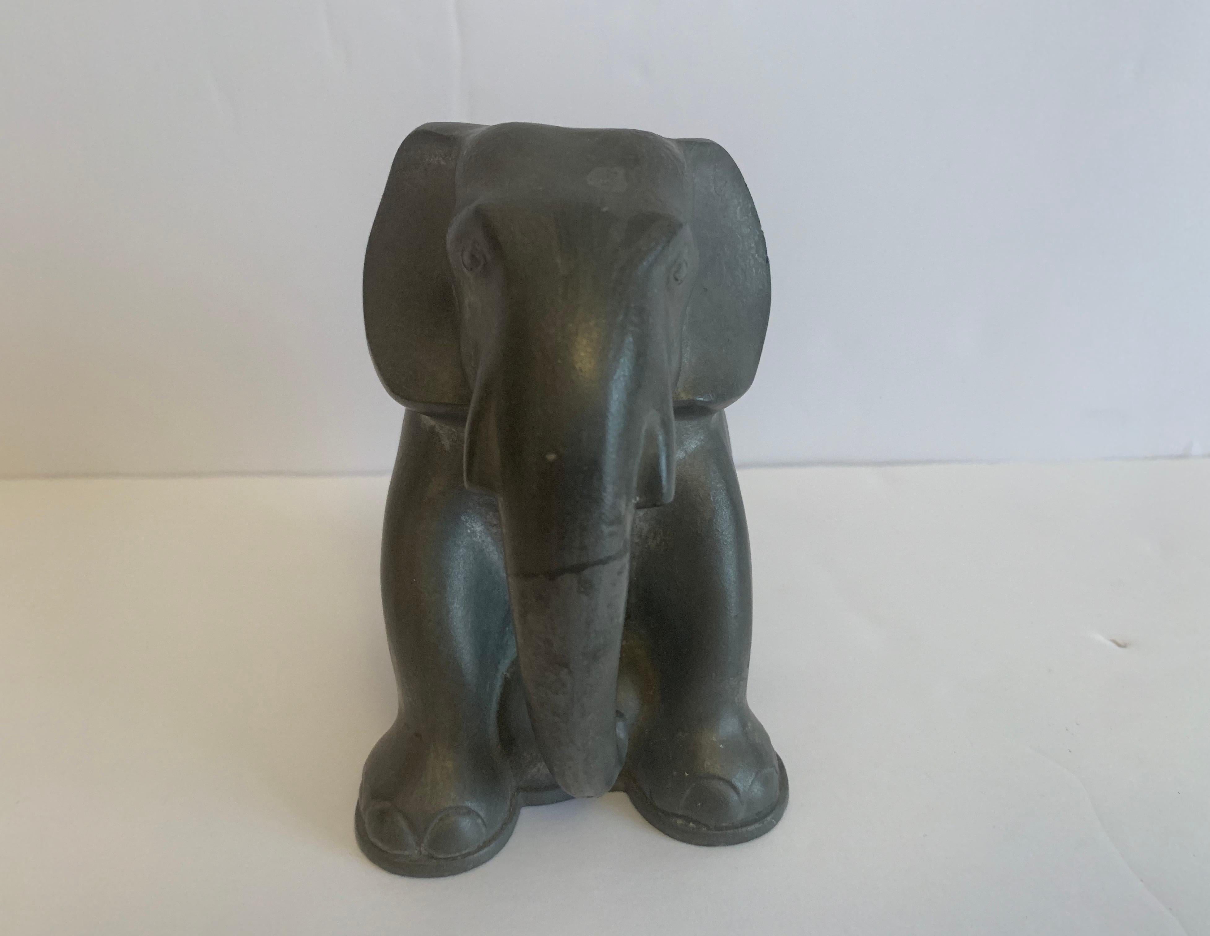 One 1930s Danish Art Deco pewter elephant bookend by sculptor, Just Andersen.