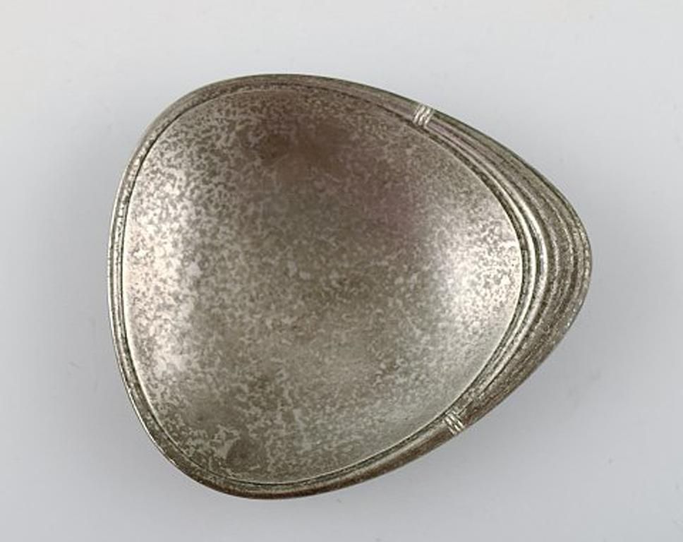 Pewter Just Andersen, a Collection of Eight Art Deco Coasters and a Small Dish