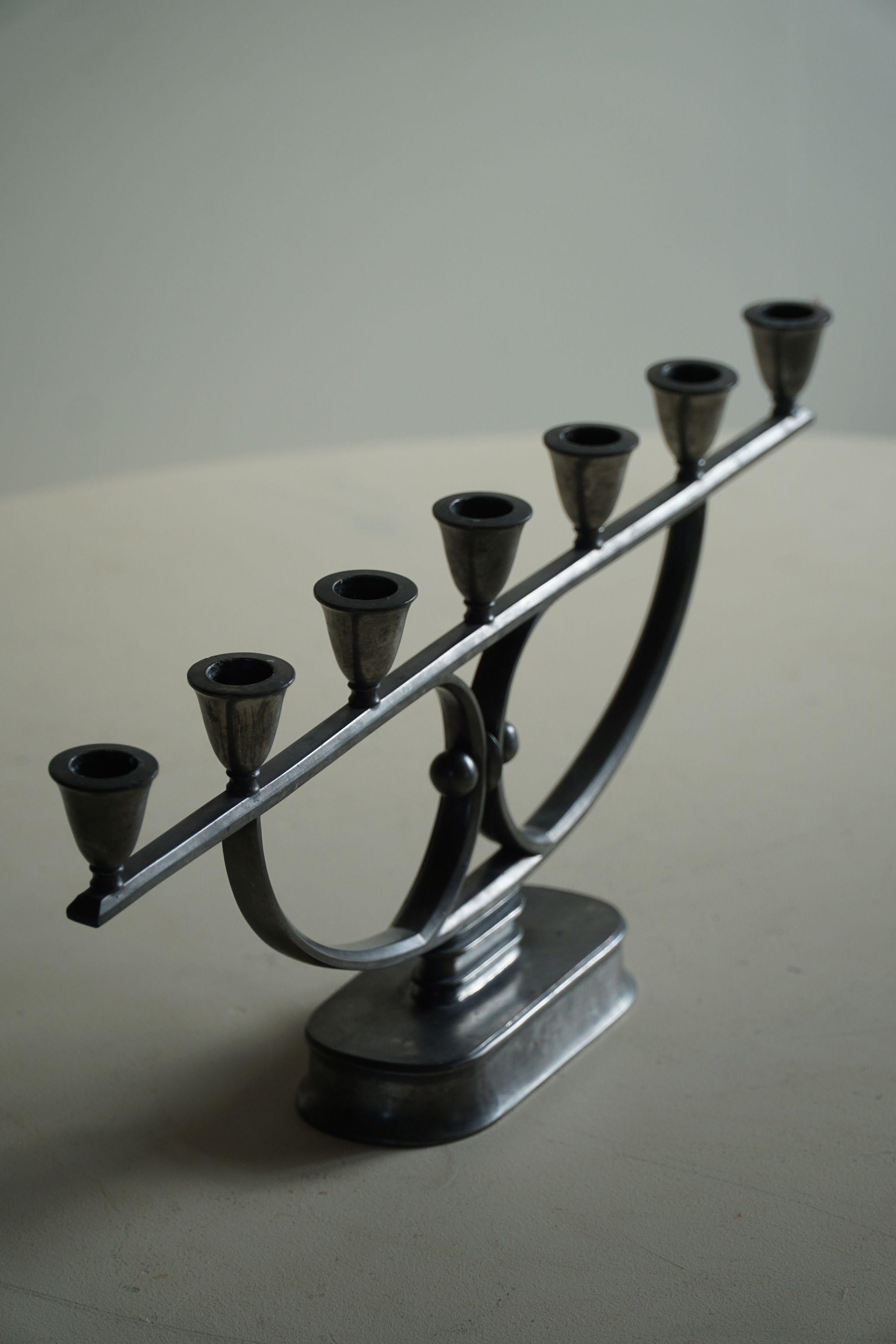 A beautiful rare large candle holder / candlestick in metal. Made by Danish designer Just Andersen in the 1920s. Signed underneath.

Just Andersen (1884-1943) is a fine representative of modern Danish neoclassicalism. In terms of style, he belongs