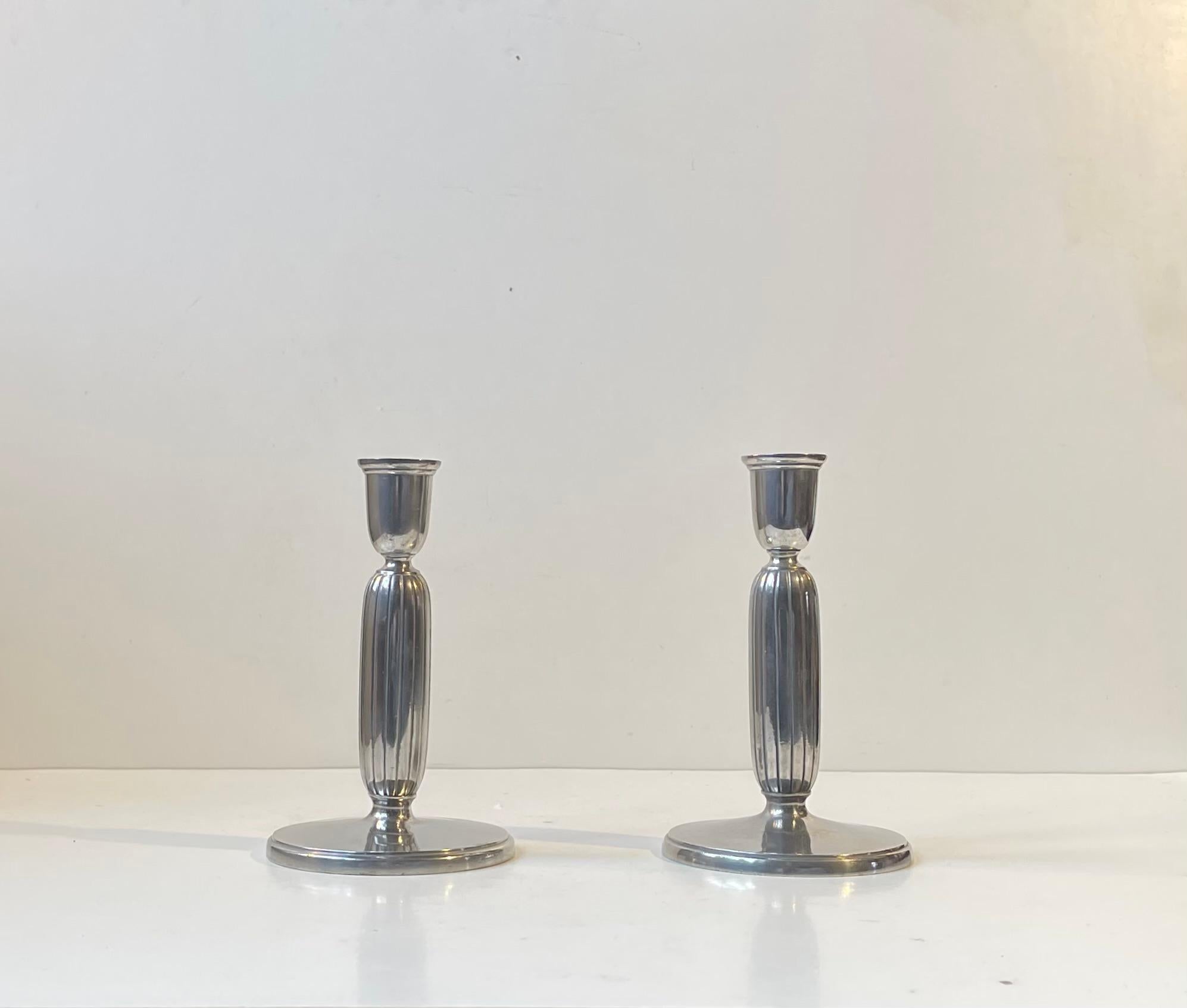 A pair of Candlesticks designed by Sculptor Just Andensen in Denmark during the 1930s or 1940s. They are made from the finest pewter - Selangor Pewter. Distinct architectural art deco styling with perfectly balanced fluted organically shaped
