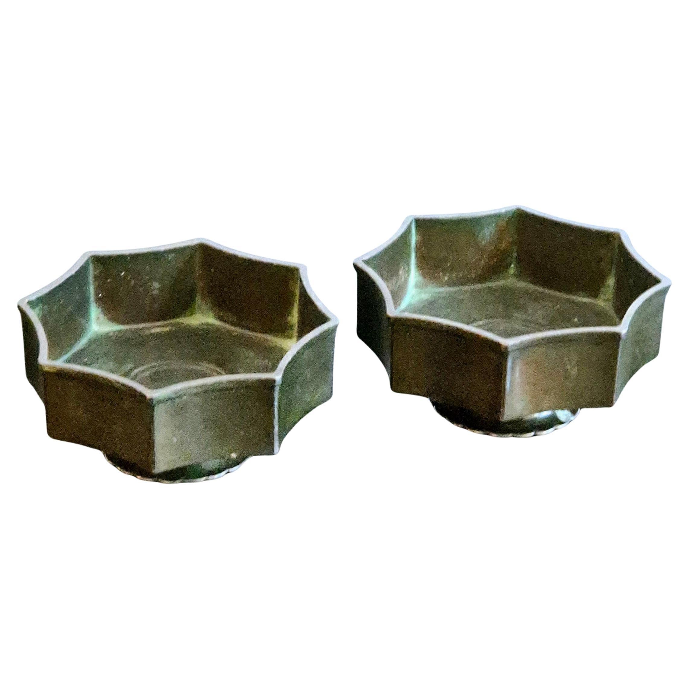 Una coppia decorativa e rara di portacandele/ciotole su piede di Just Andersen, Danish Grace 1920/30s. Capovolgili: un lato funziona come portacandele per le luci da tè, l'altro è perfetto come ciotola.

La coppia è realizzata in metallo Disko.