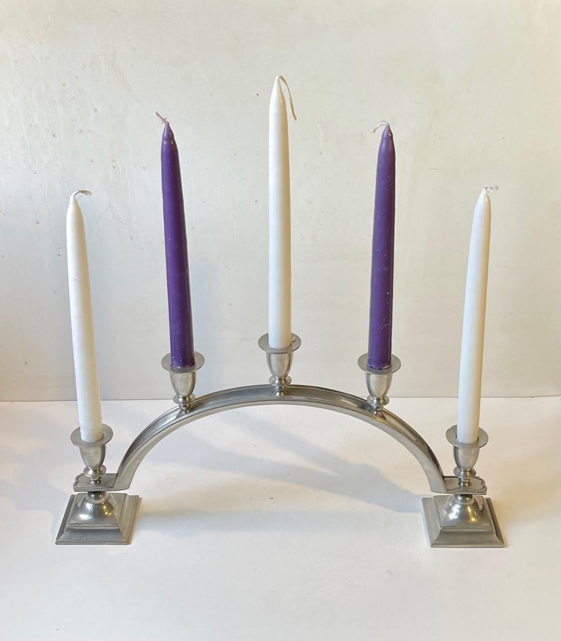 Important and very rare Just Andersen pewter candelabra in an arched design. Distinct architecturally inspired Art Deco styling with its discrete decor and 'staired' configuration. It is to be fitted with 5 regular sized candles over its reach/width