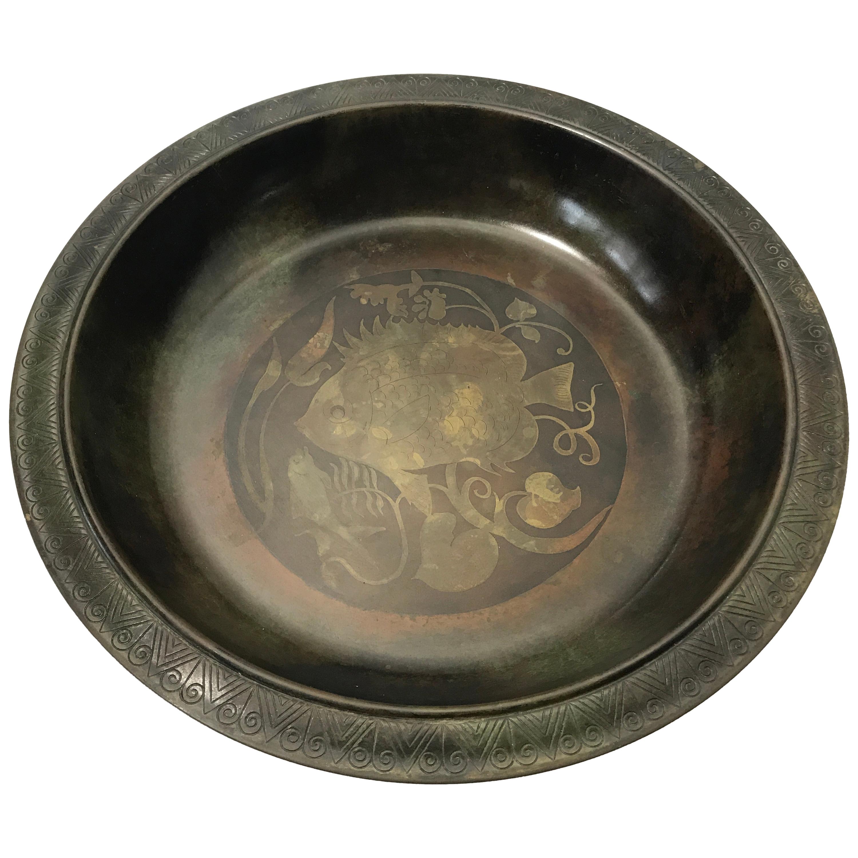 Just Andersen of Denmark patinated bronze bowl inlaid with two stylized fish surrounded by sea foliage. Engraved tooled edge to rim. Rich and aged patina,
circa 1930s.
A substantial piece of Just Andersen's fine work
Signed and numbered B52 to