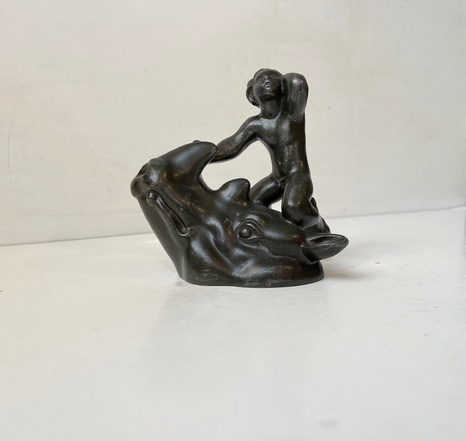 Mythologically perceived small group figurine with faun and rino by Just Andersen, Denmark. Designed and made around 1930. Composed of Just Andersens own alloy called Disko Metal. The figurine is signed to the side: Just A. and marked, Just D 1632.