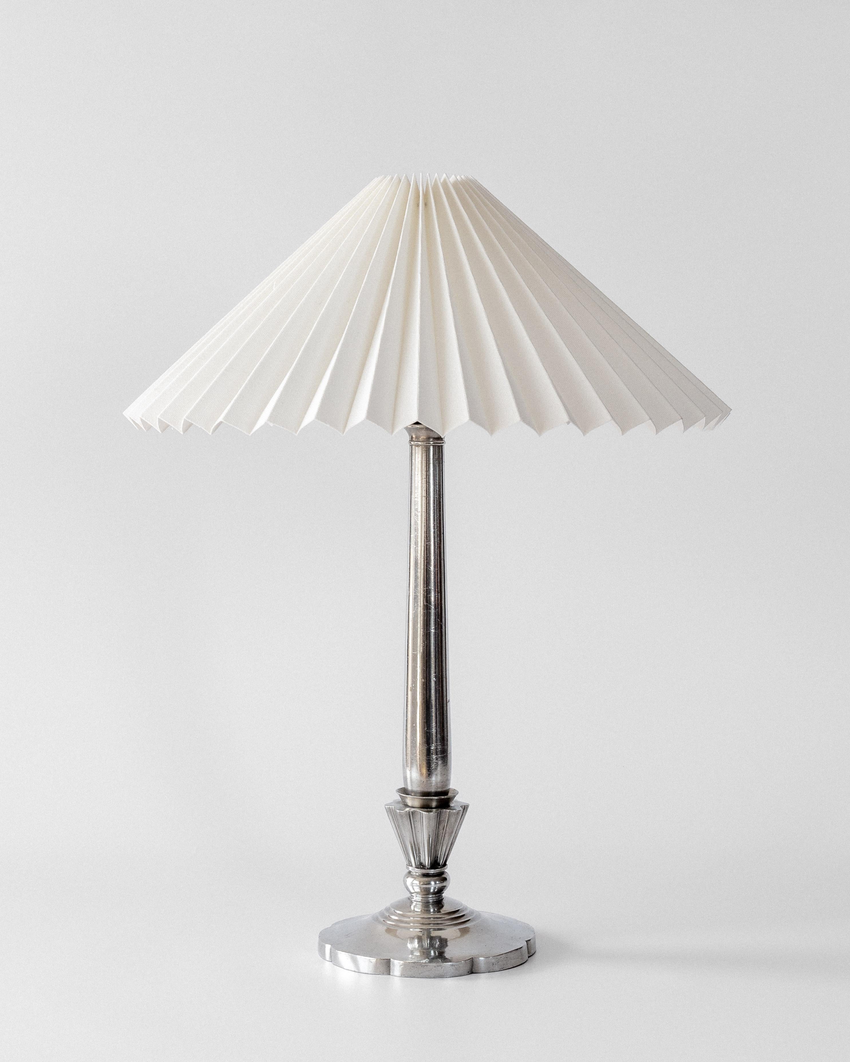 Elegant Art Deco table lamp by Danish metalsmith and sculptor Just Andersen, crafted circa 1930. This well-preserved piece displays the clean lines and thoughtful craftsmanship that made Andersen's work so distinctive.

The pewter construction