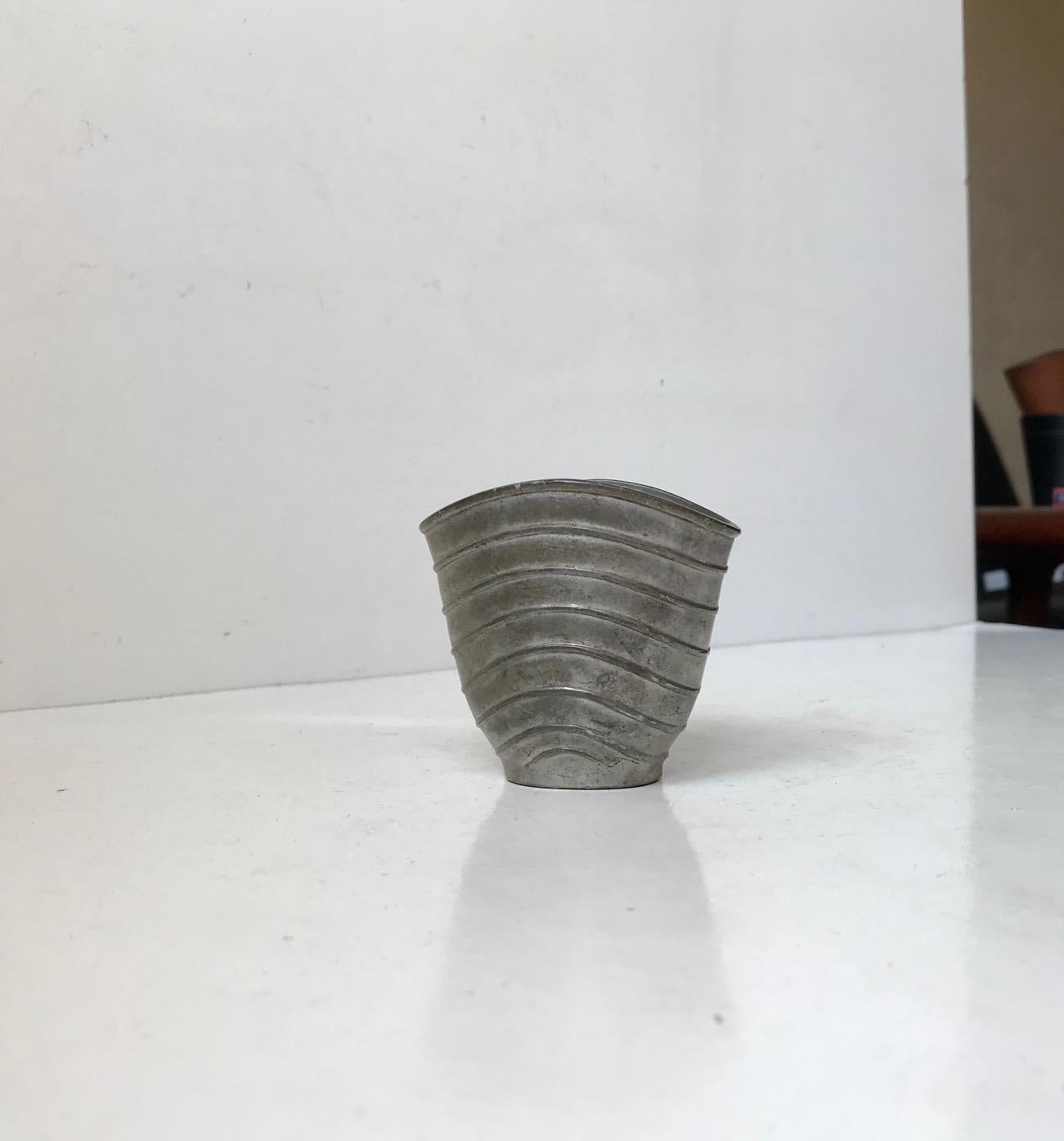 A rare pewter vase with wavy ribbings. Designed and manufactured by Just Andersen in Denmark during the 1930s. Imprinted to its base: Just, Danmark, 2505. Measurements: H: 6.8 cm, W/D: 7.3/5,5 cm.