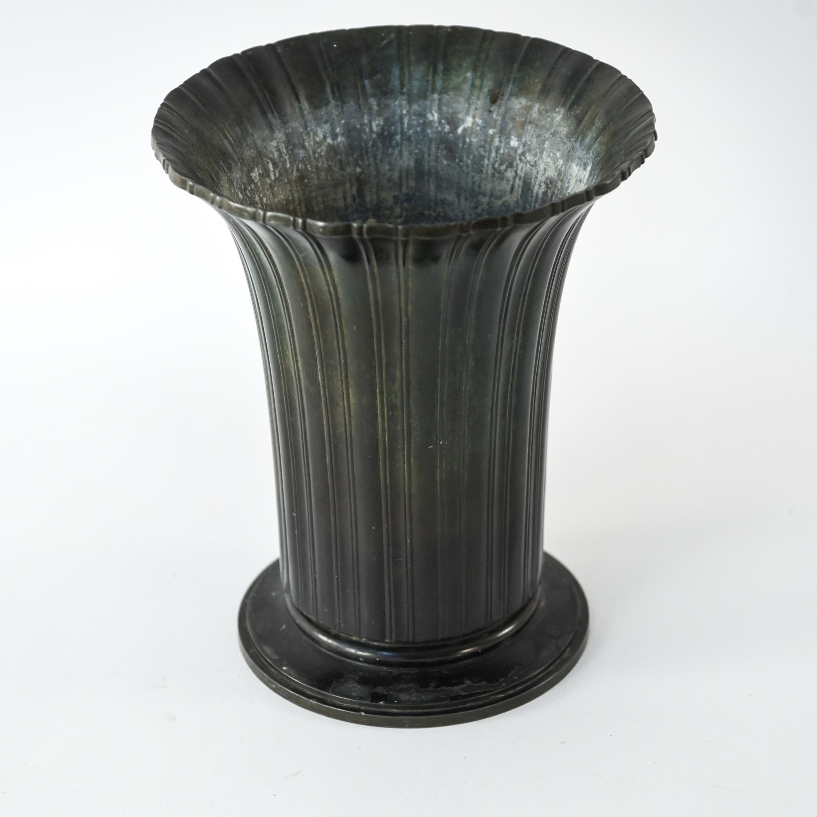This Art Deco bronze vase by Just Andersen is of a timeless form and features ribbed sides and a wide opening. Marked on base: 1919-17.2-1944. Marked underneath: Denmark 1940.