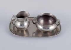Just Andersen, creamer and sugar bowl on tray in pewter. 940s.