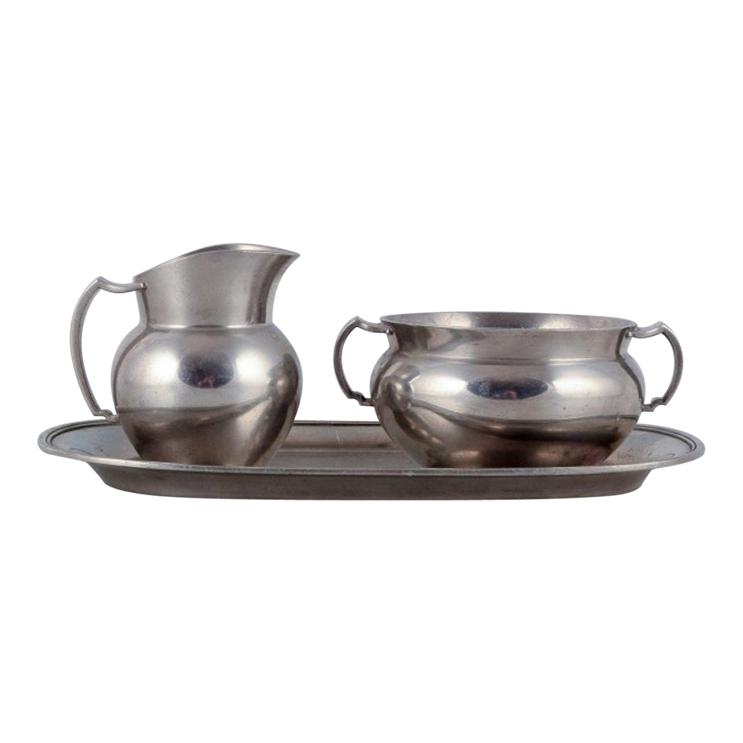 Just Andersen, creamer and sugar bowl on tray in pewter. 940s.