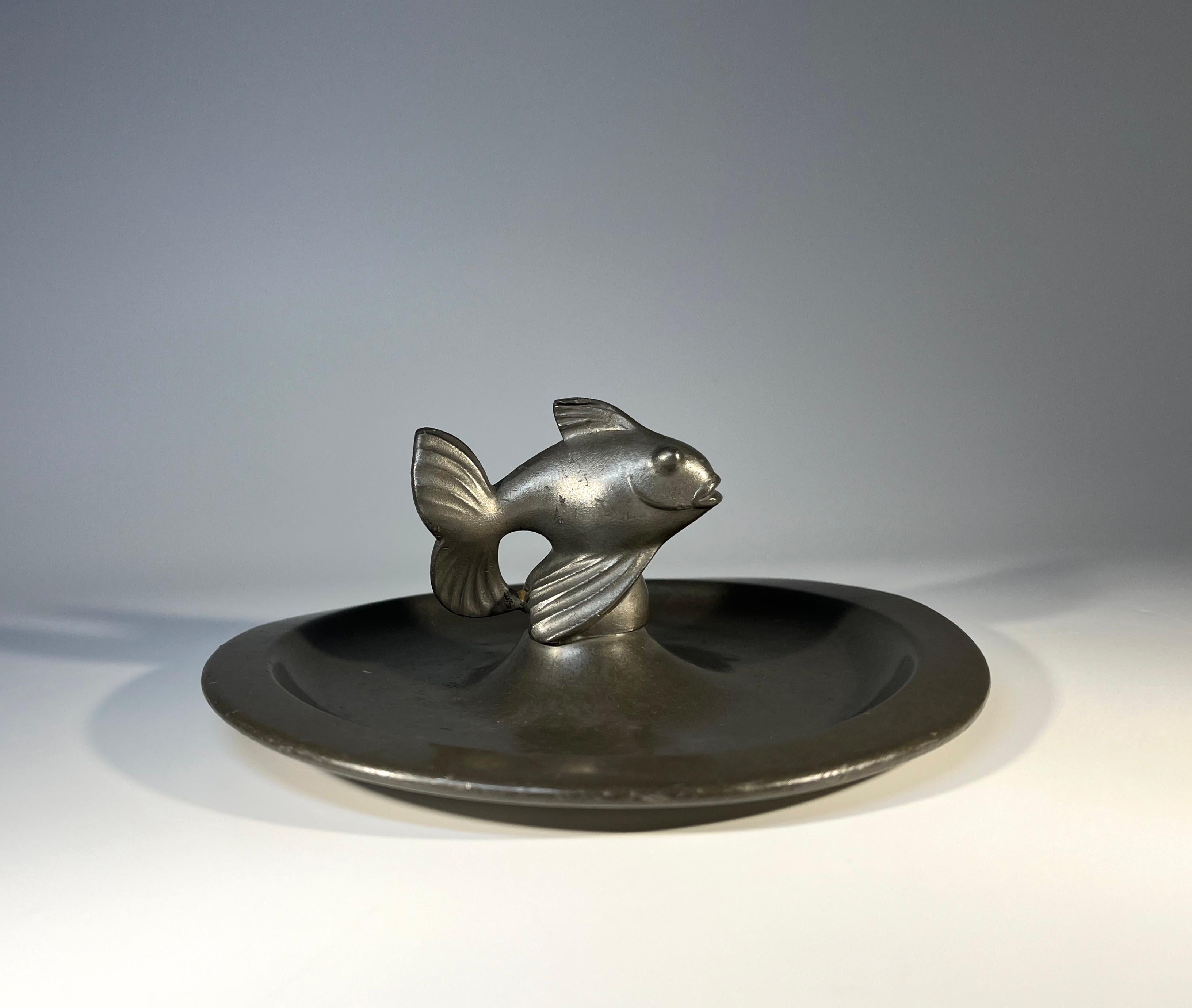Just Andersen, Denmark 1930s Art Deco pewter stylised fish vide poche
Circa 1930's
Stamped and numbered 1656B on base
Diameter 6 inch, Height 2.5 inch
Remarkably good condition with a dark patina
Wear consistent with age and use