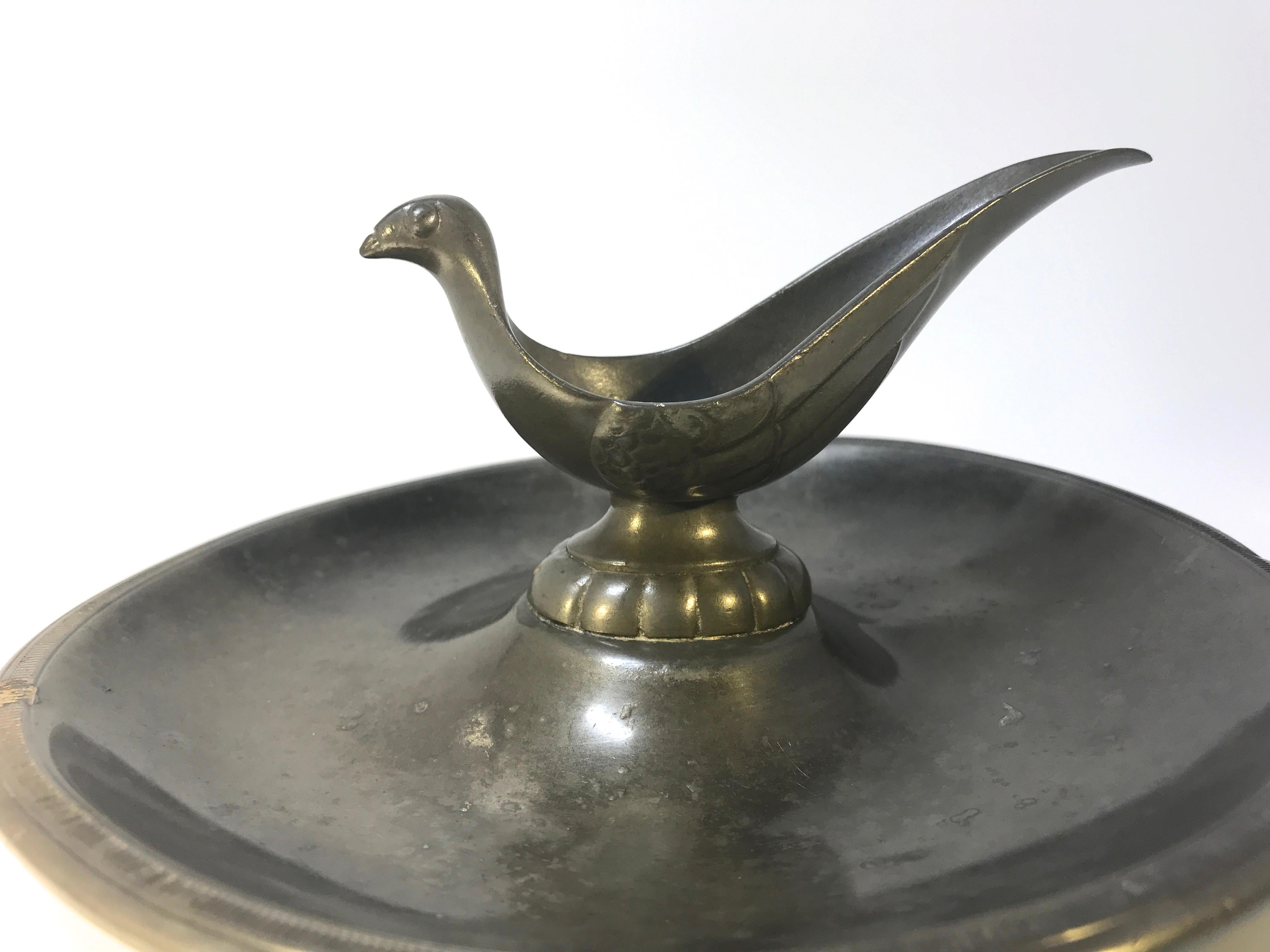 Just Andersen, Denmark 1930s Deco Pewter stylized bird pipe holder ashtray #2062
Stamped and numbered 2062 on base
Measures: Diameter 7 inch, height 3.5 inch
Good condition for it's age. Small pitting on tray as shown in photograph.
   
    