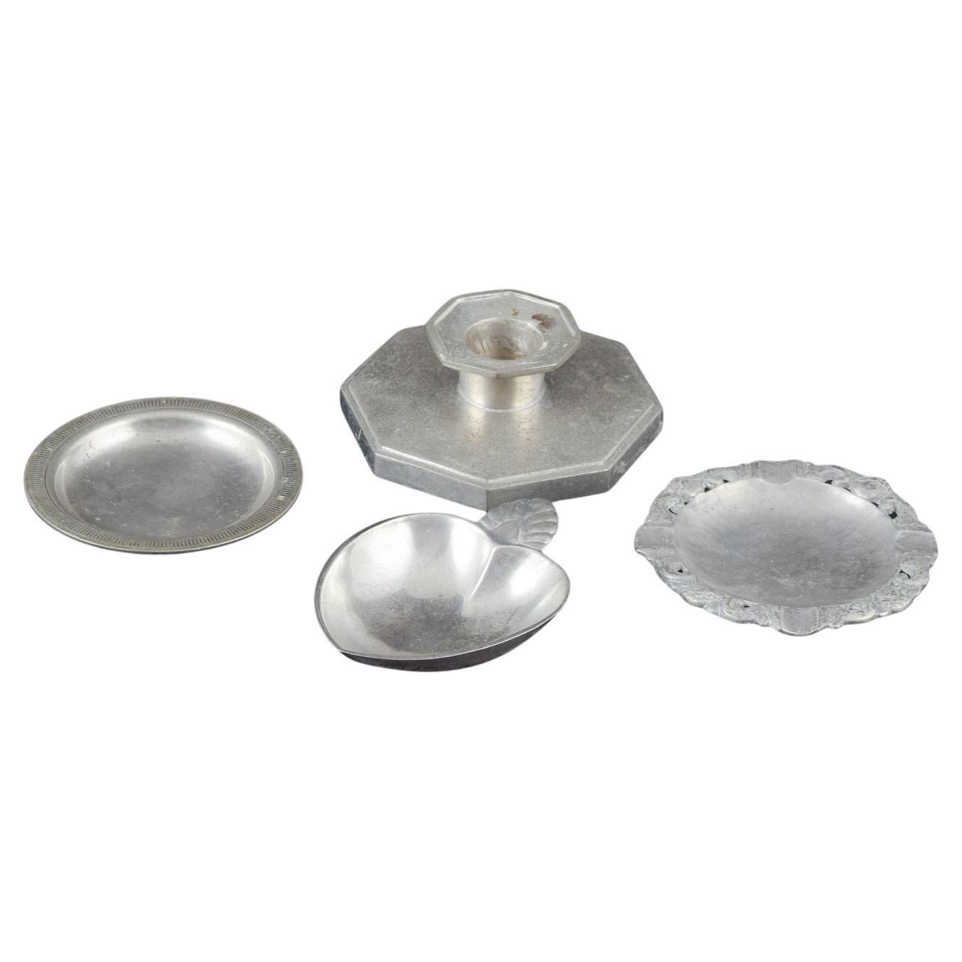 Just Andersen, Denmark. Collection of three small pewter dishes and candlestick.