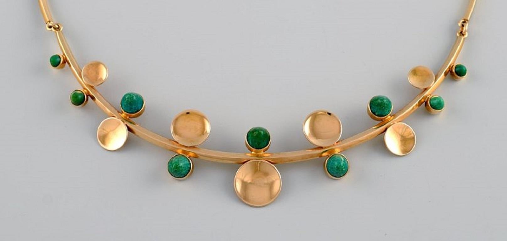 Just Andersen, Danemark. Collier en or 18 carats orné de neuf malachites de forme conique. 
1930s / 40s.
Longueur totale : 40 cm.
Poids : 29 grammes.
En parfait état.
Estampillé.