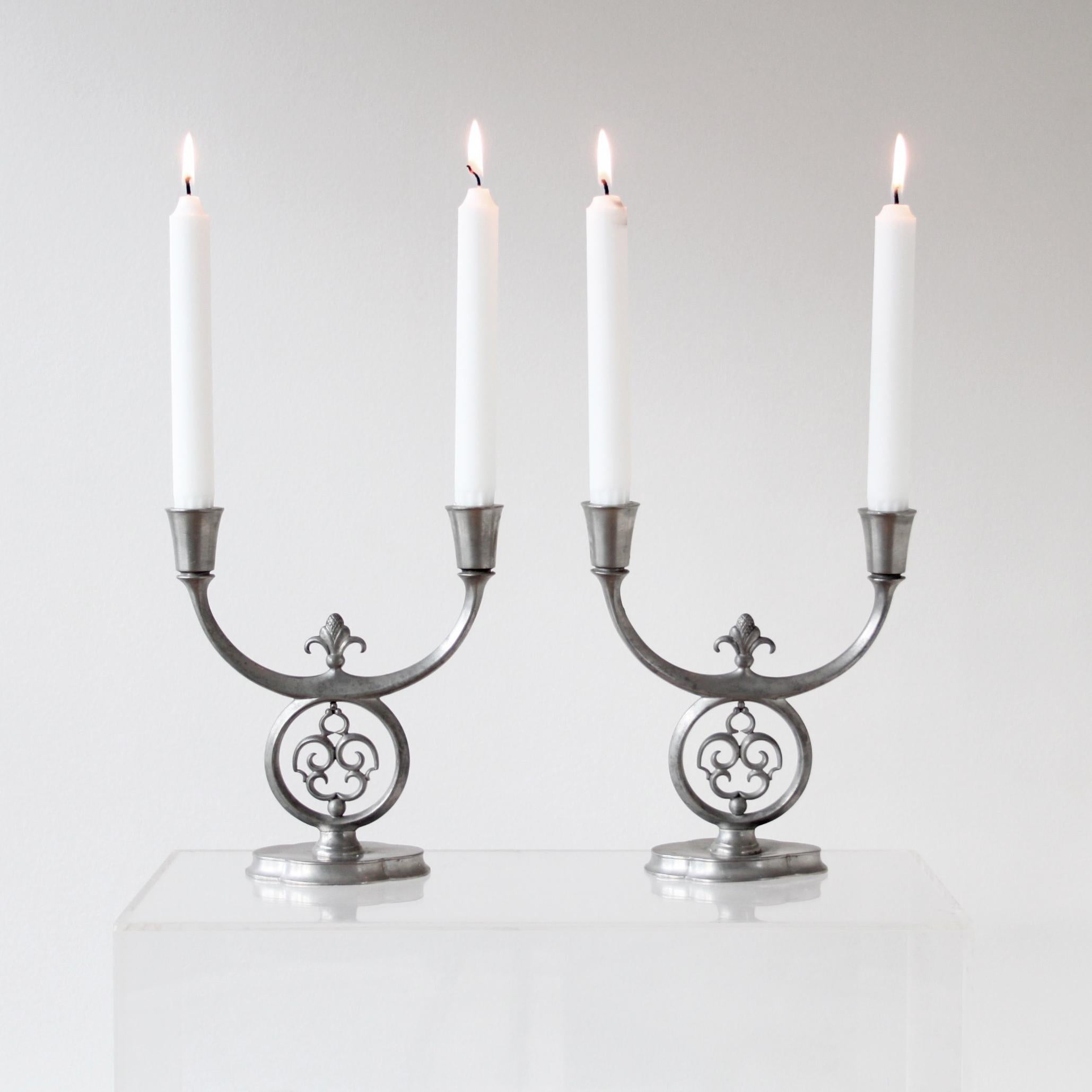 Just Andersen - Scandinavian modern.

A early a pair of pewter candelabras with two arms, Dessin 1171, manufactured in Denmark between 1918-1929. The candelabras have very fine decoration with hammered and hand-crafted details. 

Each candelabra