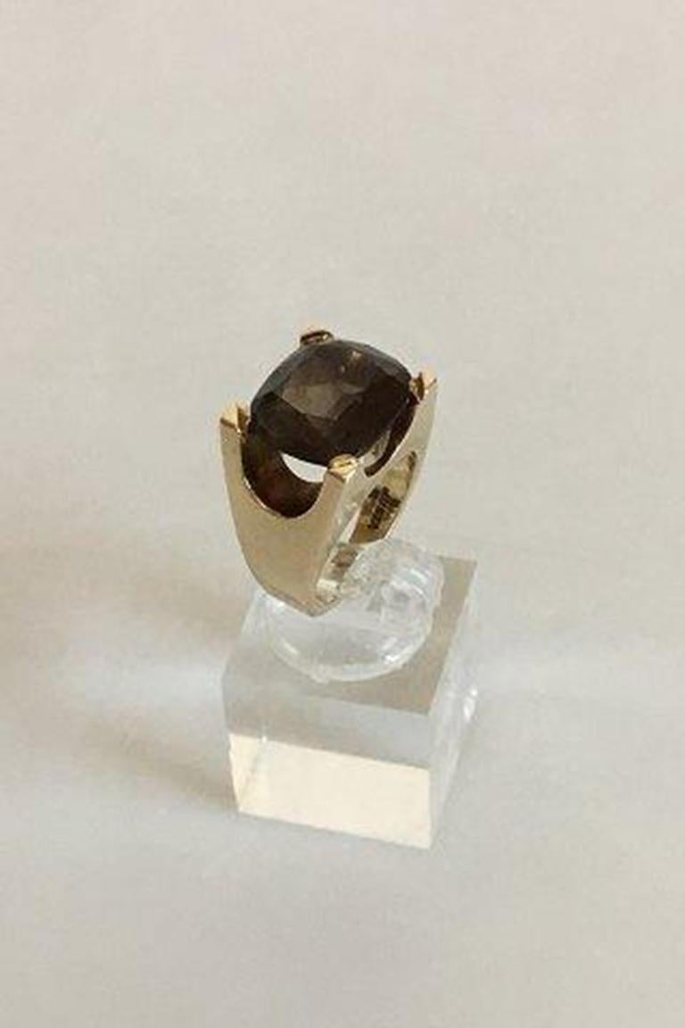 Just Andersen gold ring 14 kt. With smoke quartz stone.

Ring size 50/ US 5 1/4. Weighs 12.3 g / 0.44 oz.