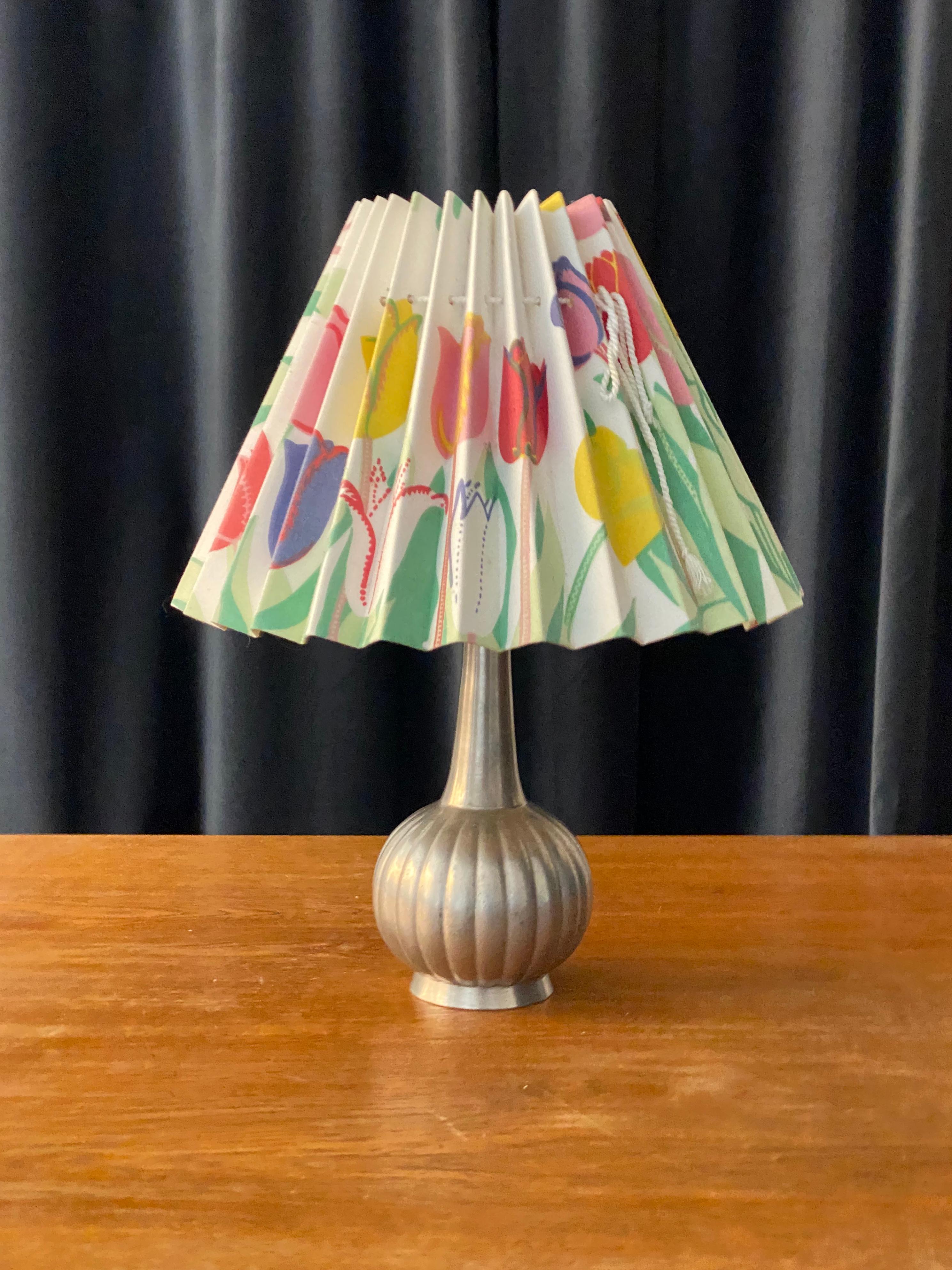 A 1930s table lamp by Just Andersen, Denmark, mounted with a screen with the iconic 