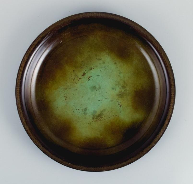 Just Andersen, low Art Deco bowl in alloyed bronze.
1930-1940s.
Marked.
Model number LB 1694.
In excellent condition with fine patina.
Dimensions: D 28.0 x H 3.0 cm.