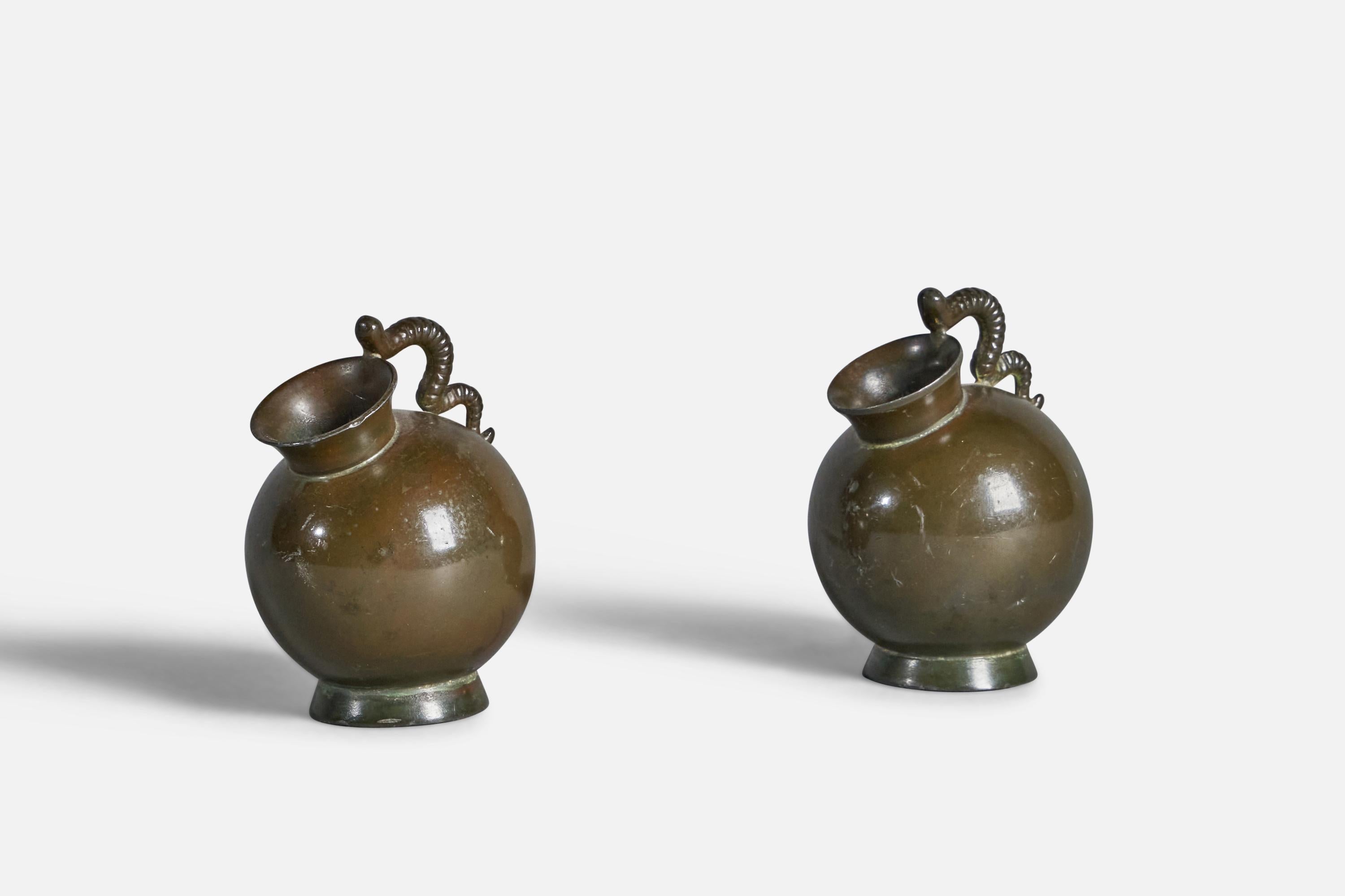 A pair of miniature disko metal pitchers designed and produced by Just Andersen, Denmark, 1930s.

”Denmark Br.H. JUSL 1282” stamp on bottom