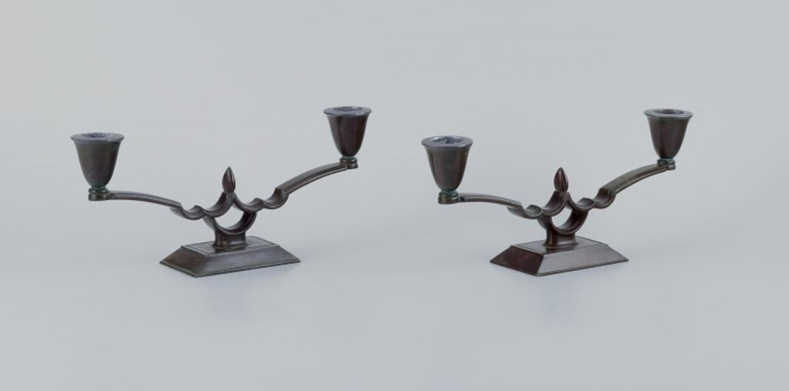 Just Andersen, a pair of two-armed Art Deco style candlesticks in 