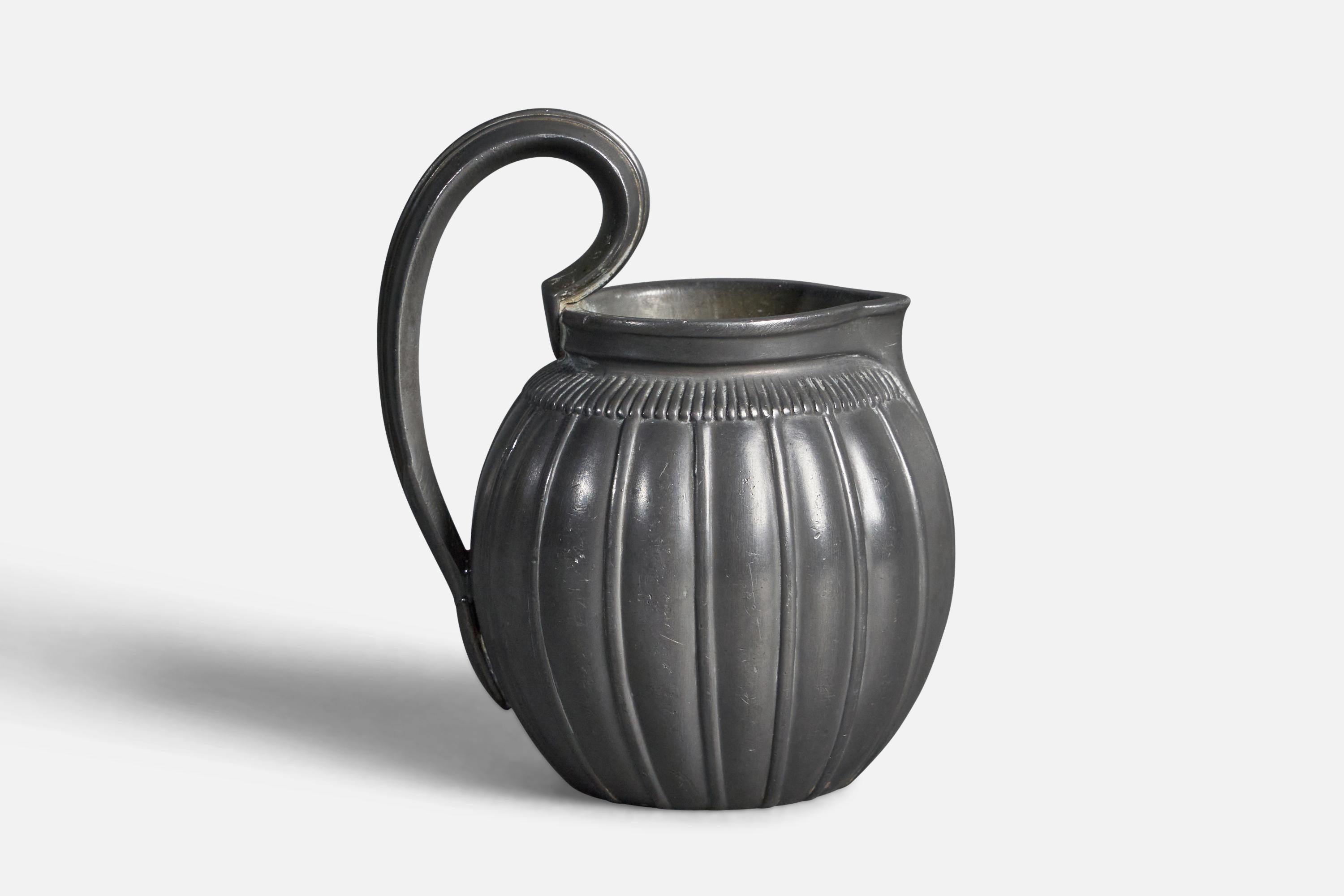 A small fluted pewter pitcher designed and produced by Just Andersen, Denmark, 1930s.