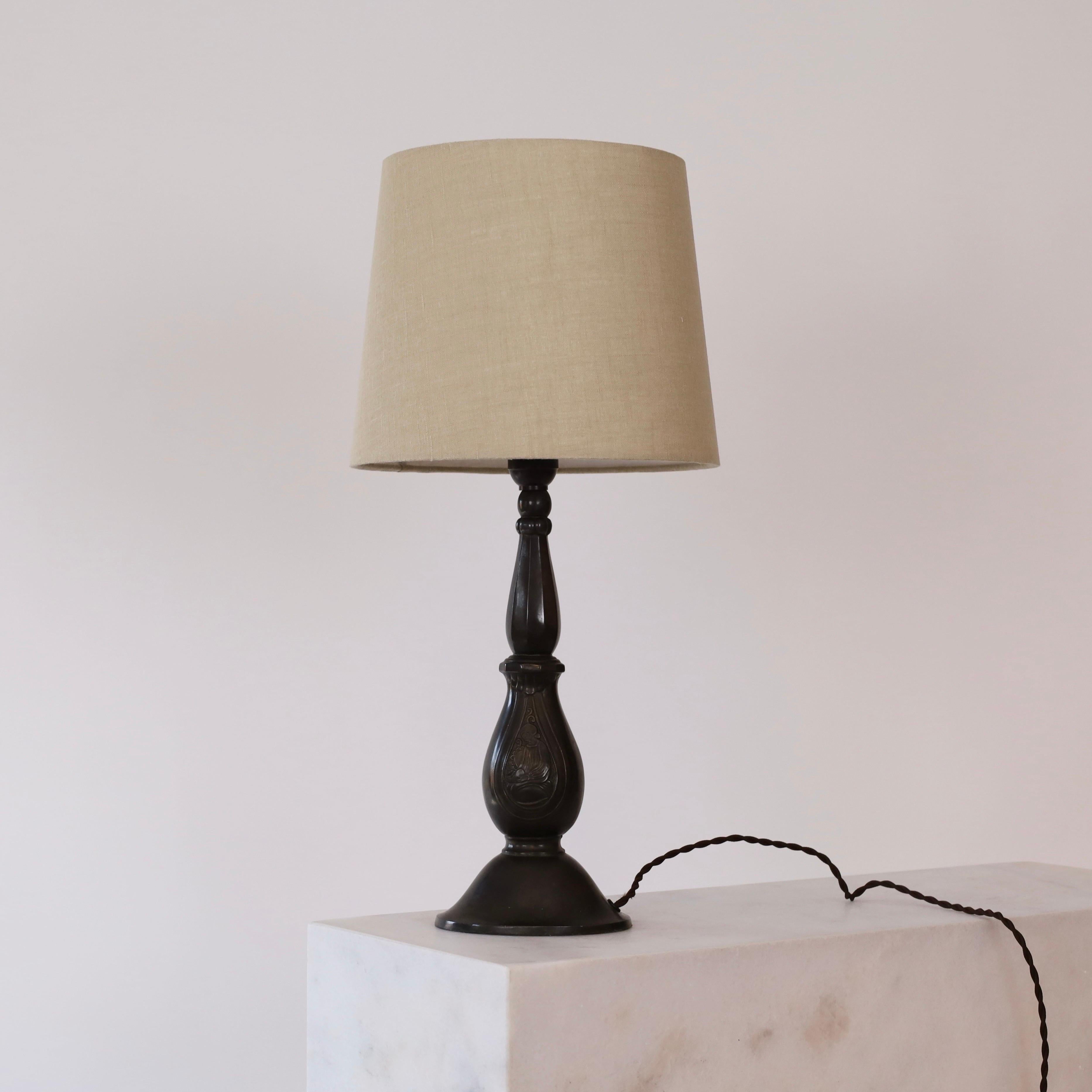 A table lamp by Just Andersen in great vintage condition. It is part of Just Andersens early work and true testament to his contribution to the Danish art deco movement in the 1920s. A piece for a beautiful home.

* Curvy metal table lamp with