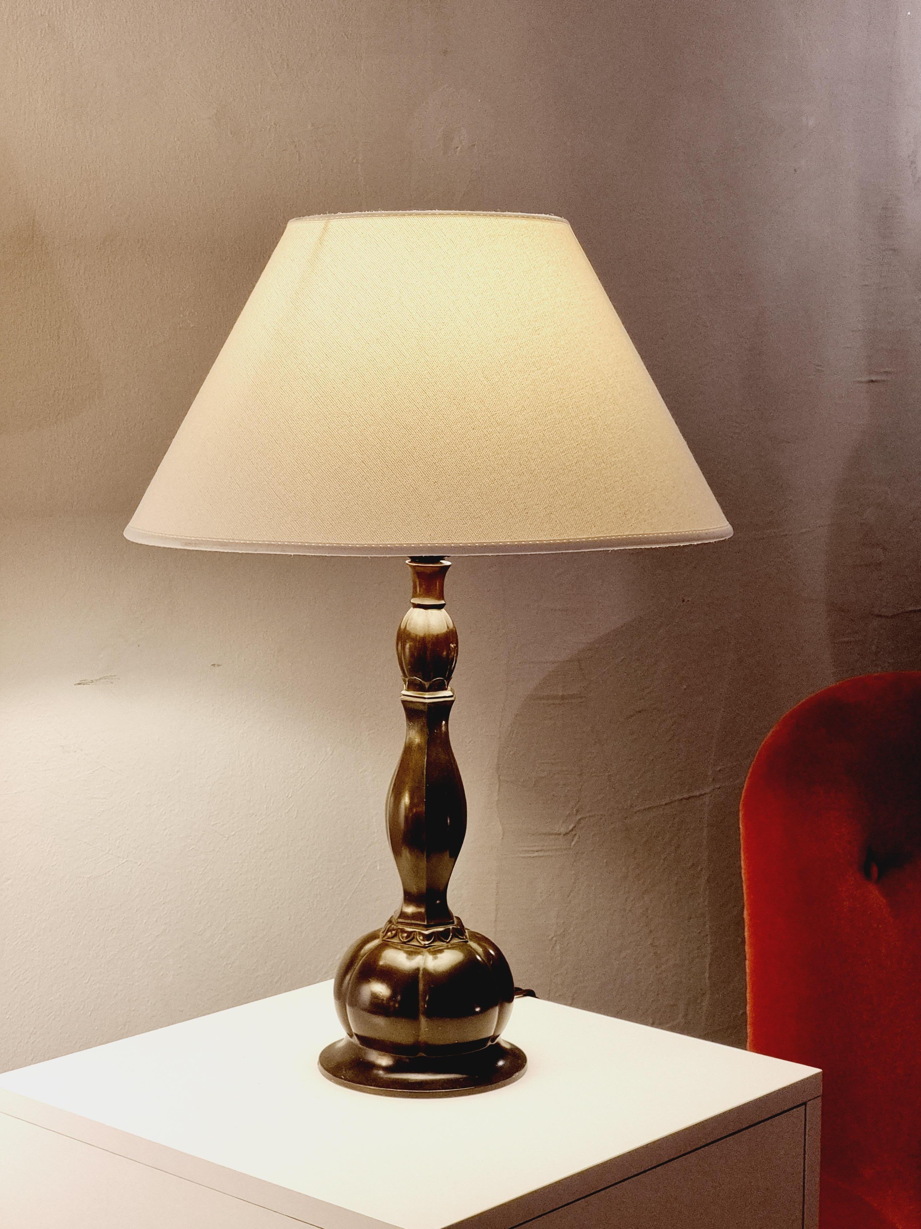 Table lamp by the danish master of bronze and inventor of the so called Discometal Just Andersen. This rare model in discometal has beautiful, soft shapes typical of Scandinavian 1930s / Art Deco. 

It has smaller signs of age and wear, a few