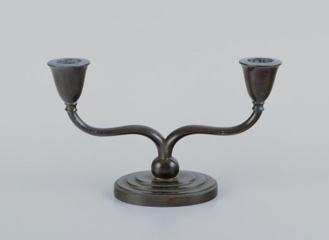 Just Andersen, a pair of two-armed Art Deco style candlesticks in 
