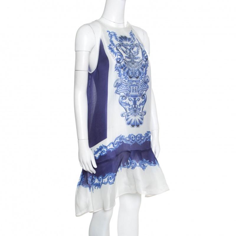It's time to glam up your style quotient with this ravishing blue and white sleeveless dress from Just Cavalli. This lovely dress is amd eof 100% silk and shines with a Majolica print over it. Featuring a round neckline and a peplum silhouette, it