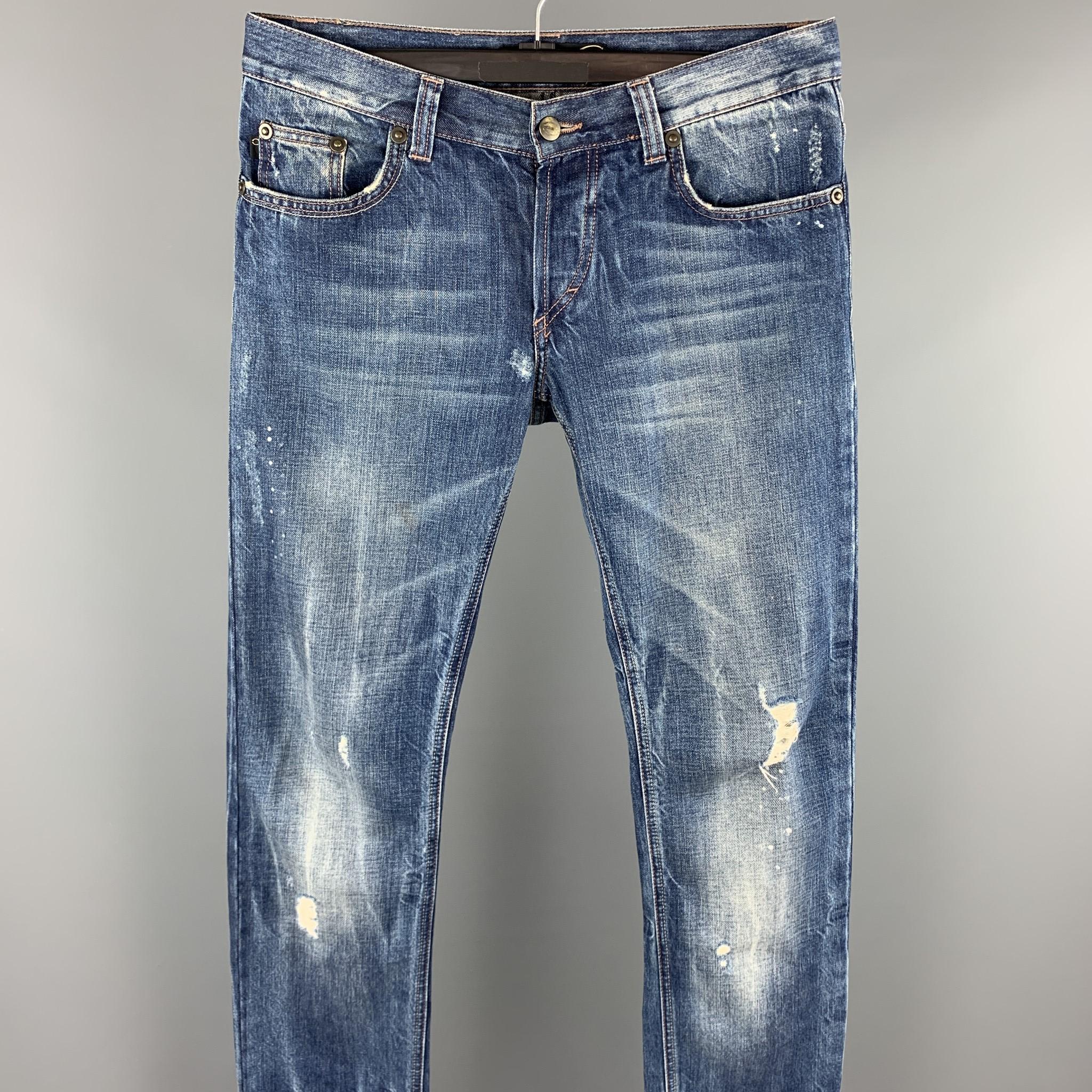 JUST CAVALLI jeans comes in a indigo distressed denim featuring a slim fit, low rise, contrast stitching, and a button fly closure. 

Very Good Pre-Owned Condition.
Marked: 31/45

Measurements:

Waist: 32 in. 
Rise: 7.5 in. 
Inseam: 34 in. 