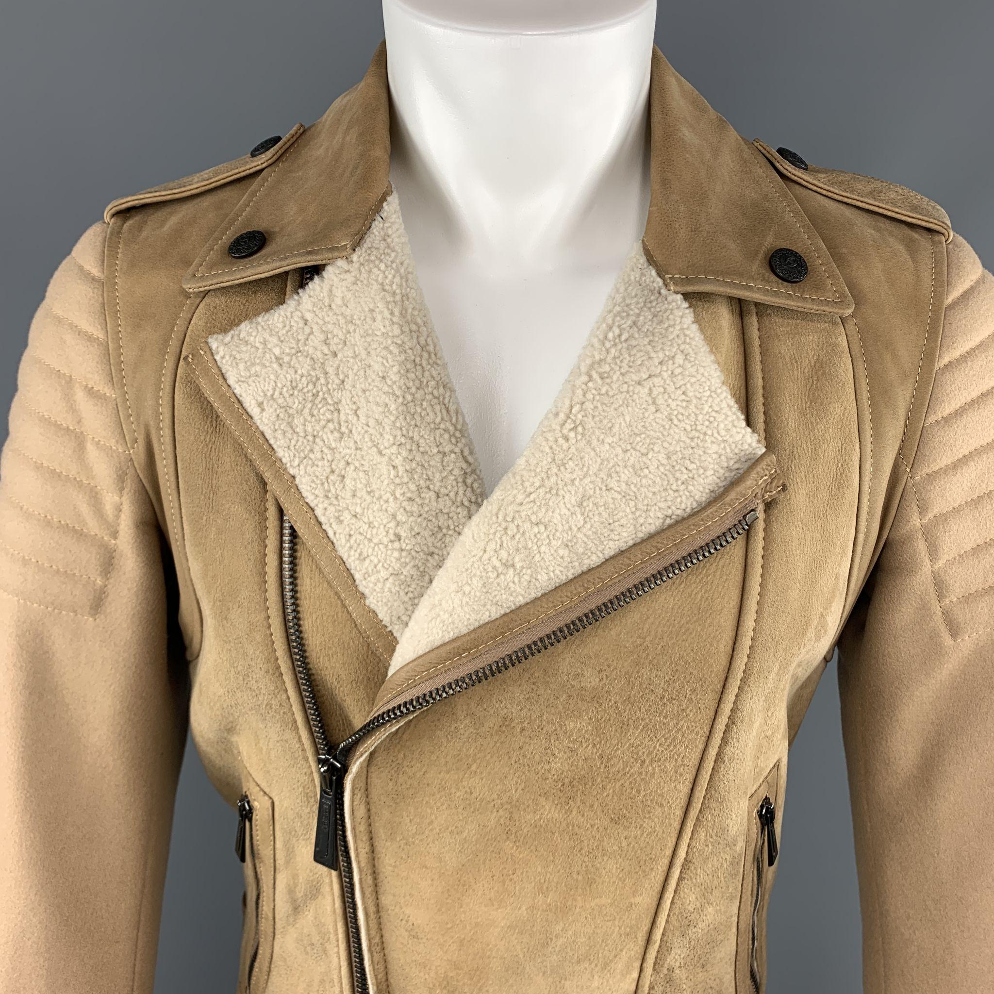 

JUST CAVALLI by ROBERTO CAVALLI biker jacket comes in tan textured shearling leather with an asymmetrical zip closure,  fur lapel, epaulets, slanted zip pockets, and camel wool padded sleeves and back panel. 

Excellent Pre-Owned