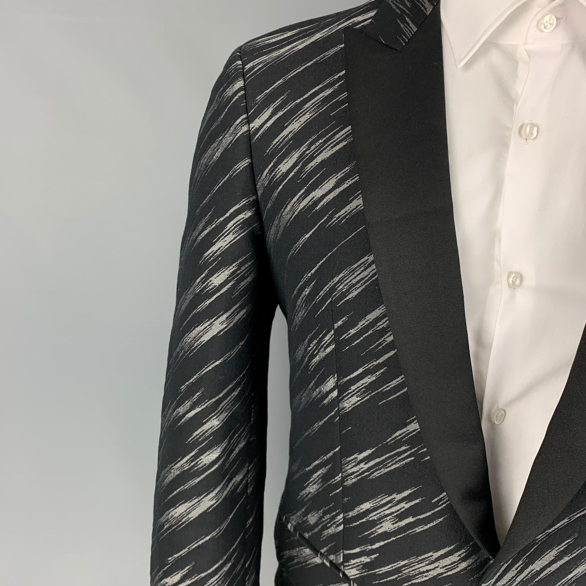 JUST CAVALLI sport coat comes in a black & grey jacquard wool blend with a full liner featuring a peak lapel, flap pockets, single back vent, and a single button closure. Made in Italy.
Excellent
Pre-Owned Condition. 

Marked:   48 

Measurements: 
