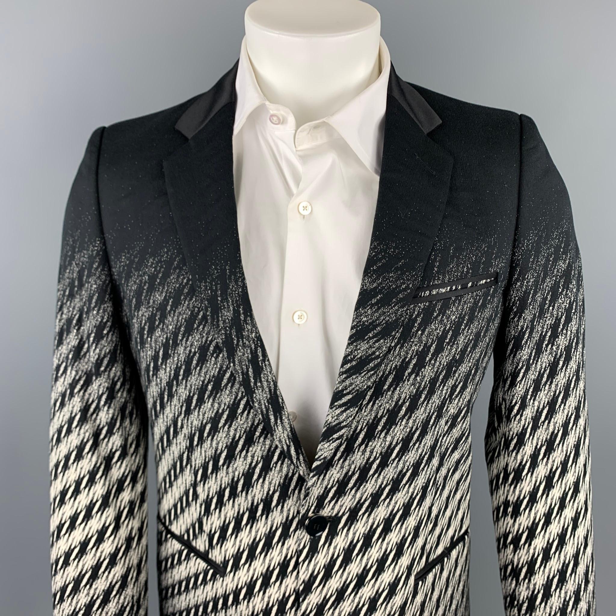 JUST CAVALLI sport coat comes in a black & white houndstooth blend with a full liner featuring a notch lapel, slit pockets, and a two button closure. Made in Italy.

Very Good Pre-Owned Condition.
Marked: IT 48

Measurements:

Shoulder: 16.5
