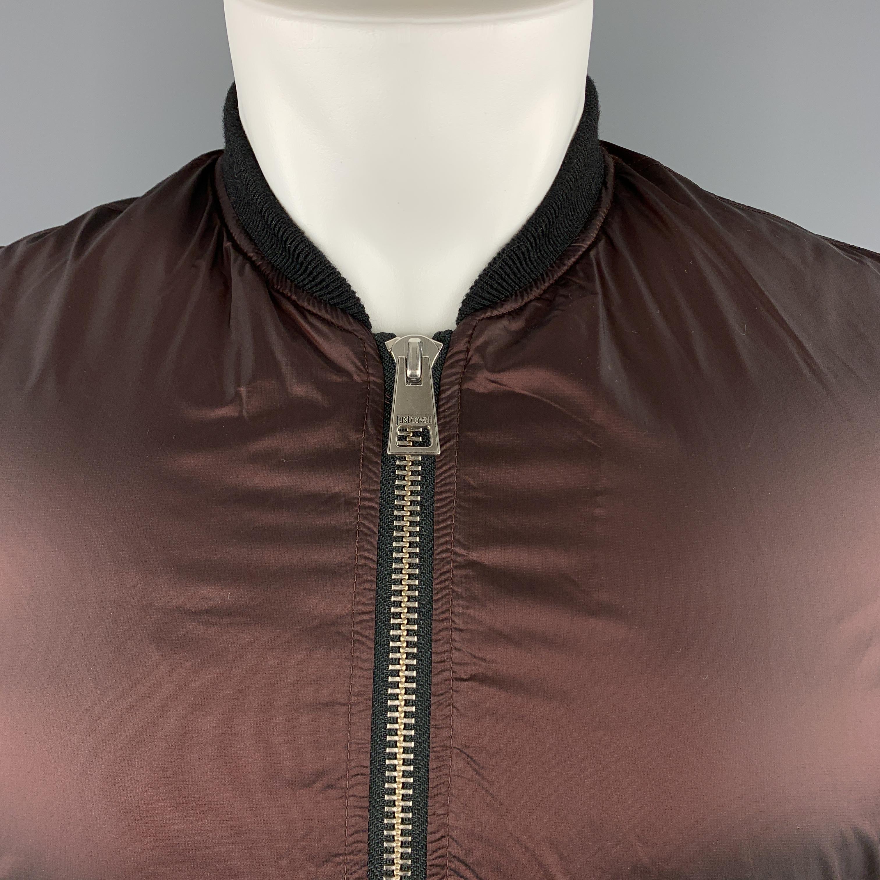 JUST CAVALLI bomber flight jacket comes in a iridescent sheen deep burgundy brown fabric with a black baseball collar and zip up front. 

Excellent Pre-Owned Condition.
Marked: IT 48

Measurements:

Shoulder: 17 in.
Chest: 44 in.
Sleeve: 26