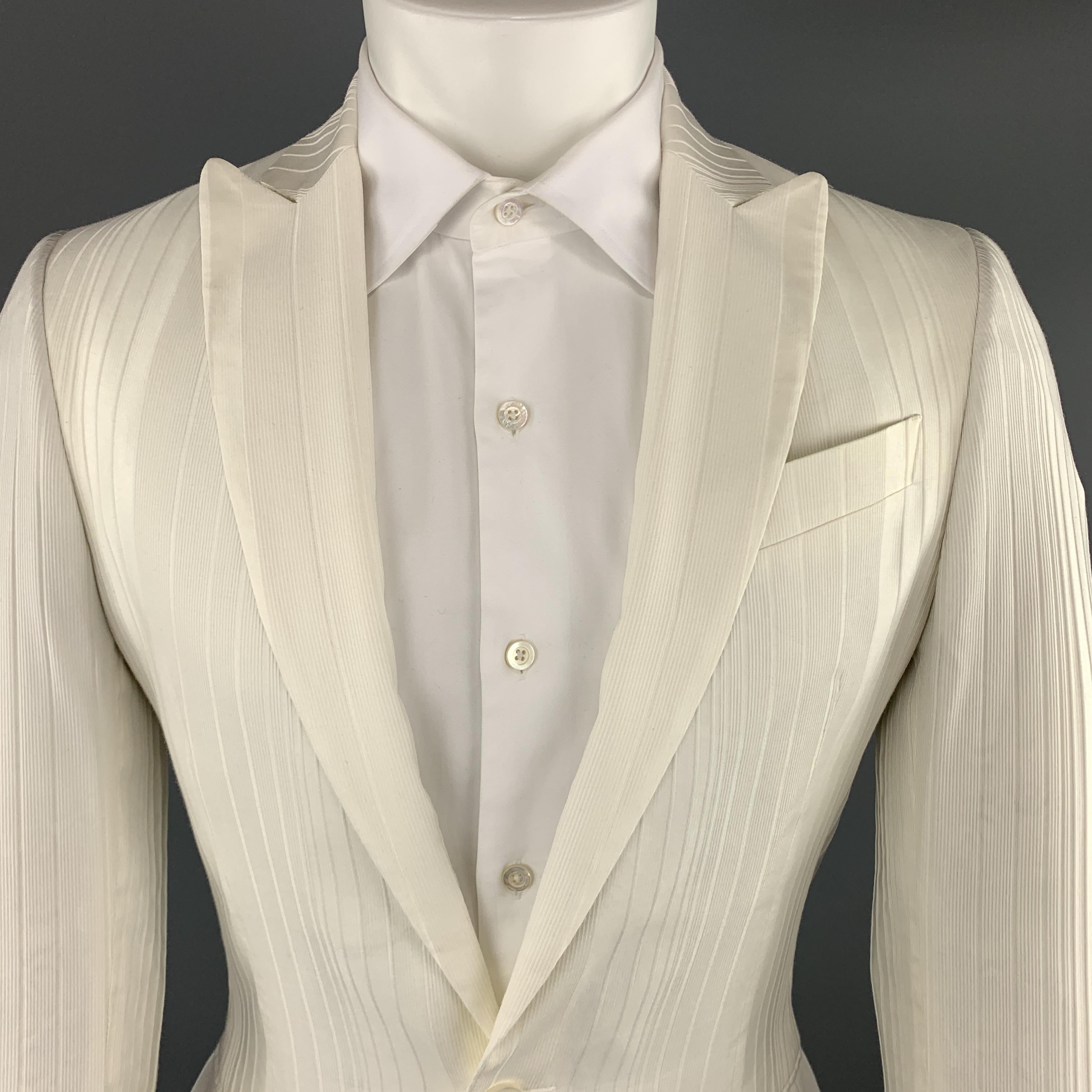 JUST CAVALLI by ROBERTO CAVALLI sport coat comes in cream stripe textured cotton blend fabric with peak lapel, single breasted, two button front, and white snake print liner. Made in Italy.

Excellent Pre-Owned Condition.
Marked: IT