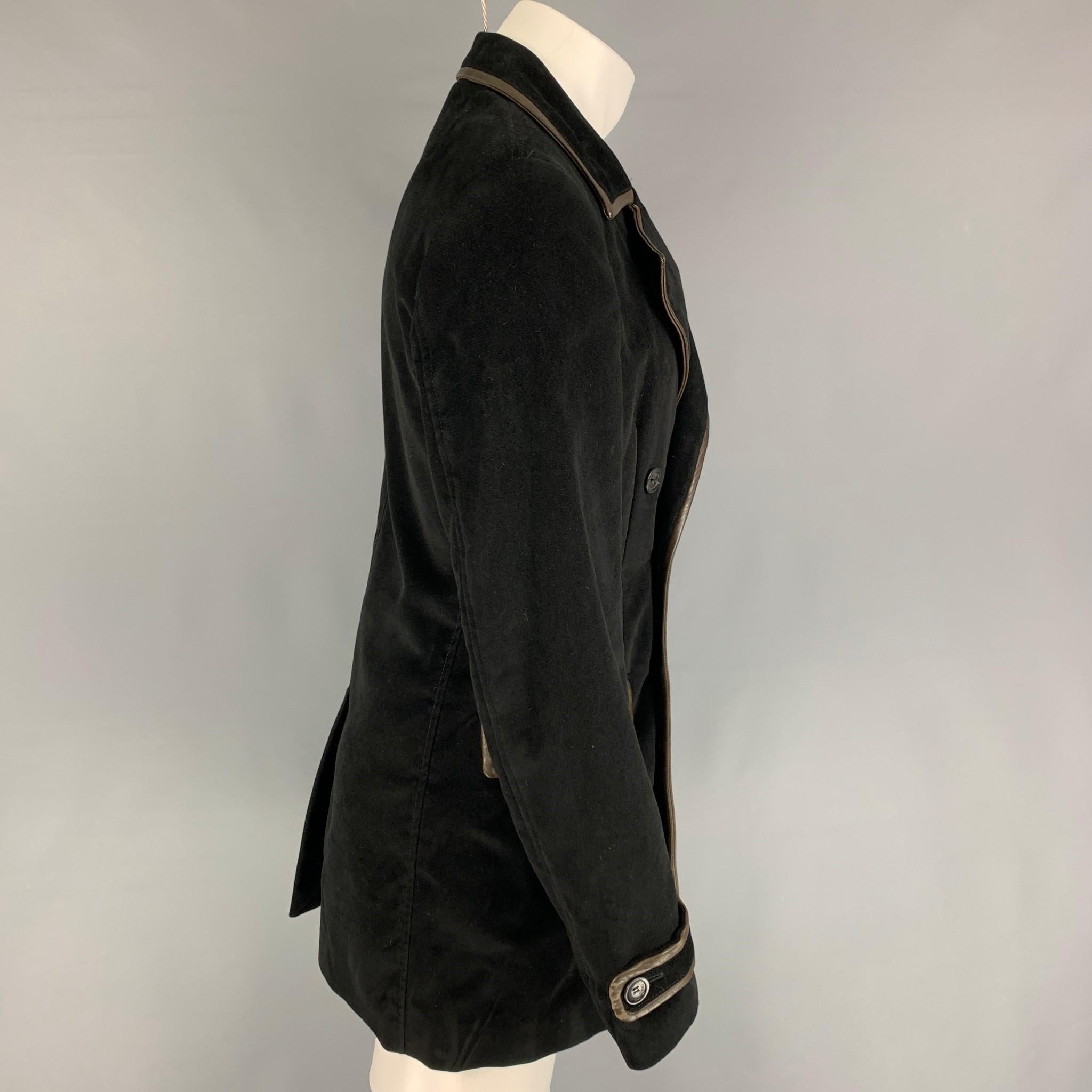 JUST CAVALLI coat comes in a black viscose / cotton with a full liner featuring a leather trim, notch lapel, lap pockets, single back vent, and a double breasted closure. Made in Italy. 

Very Good Pre-Owned Condition.
Marked: Size tag