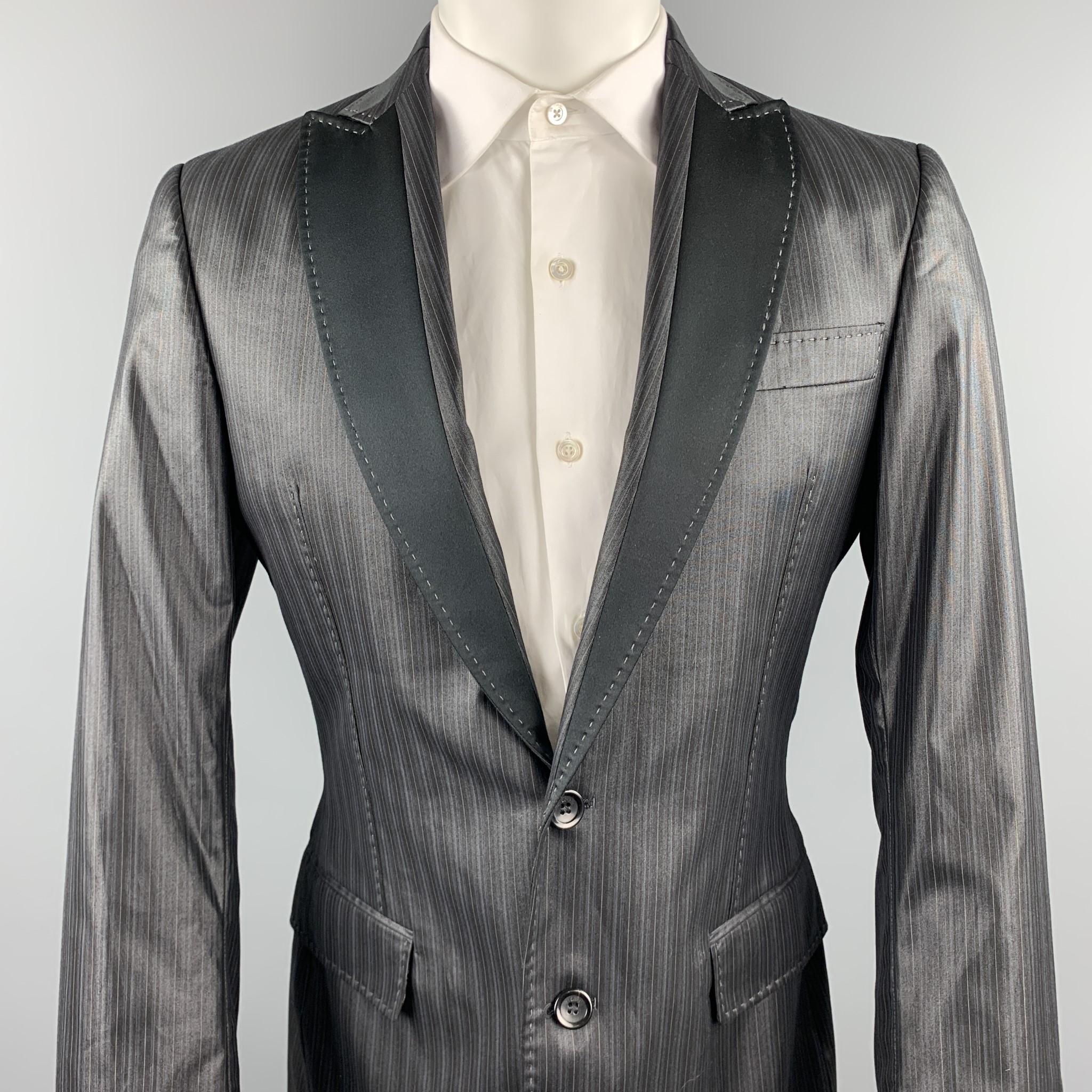 JUST CAVALLI sport coat comes in a black stripe polyester blend featuring a peak lapel style, snake print liner, contrast stitching, flap pockets, and a two button closure. Made in Italy.

Excellent Pre-Owned Condition.
Marked: IT