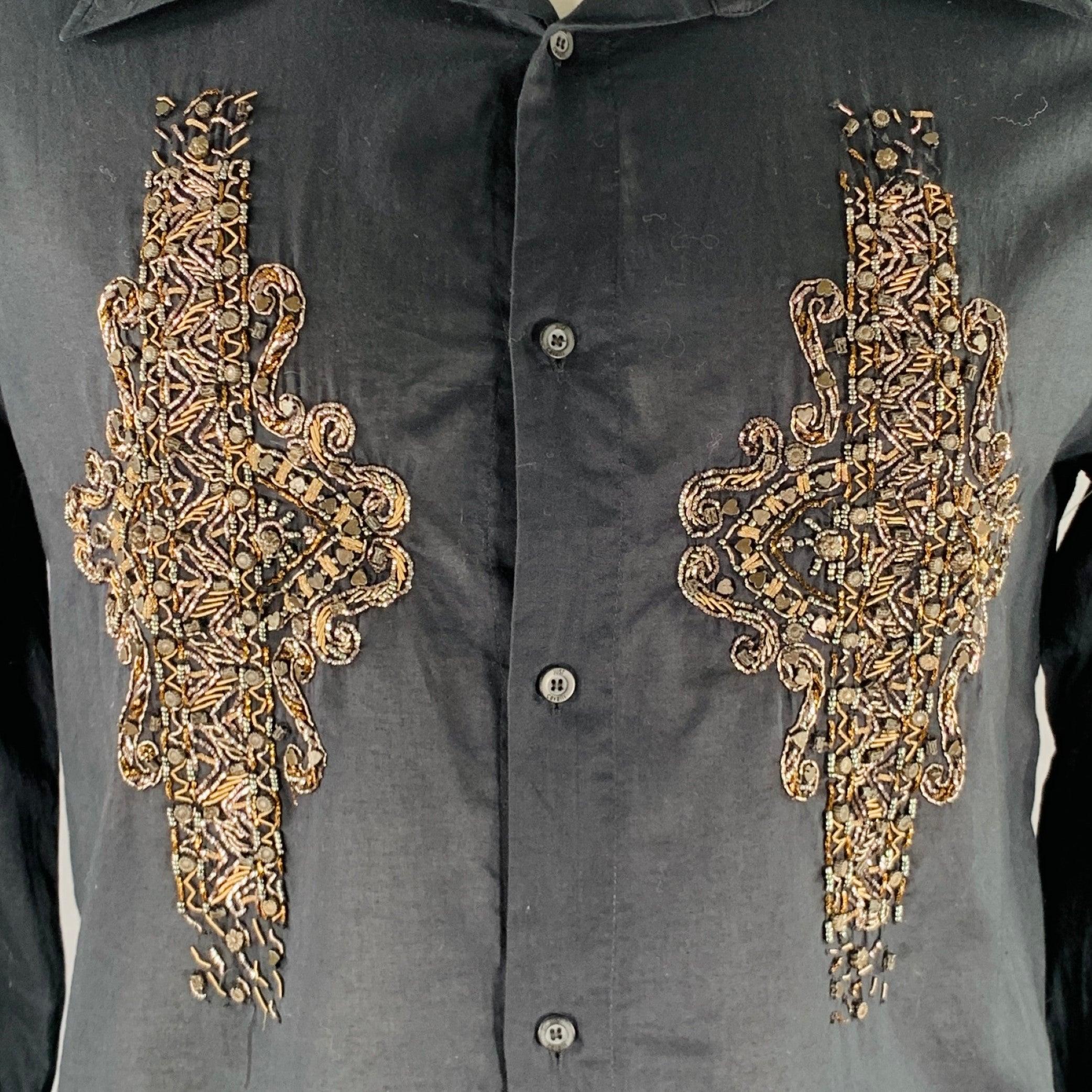JUST CAVALLI long sleeve shirt
in a
black woven fabric featuring a double gold tone metal embroidery cross design, spread collar, and button closure.Very Good Pre-Owned Condition. Minor signs of wear on embroidery, minor marks. 

Marked:   size not